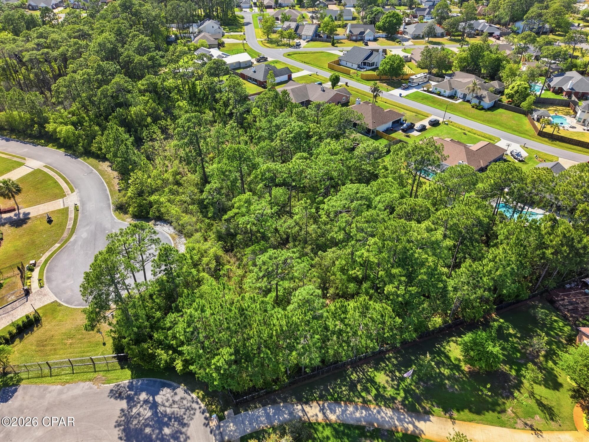 Located in the heart of the gated Trieste community, this more than 3/4-acre premium lot is one of the largest buildable homesites available and uniquely positioned across two private cul-de-sacs, offering exceptional space and privacy. Surrounded by beautifully designed Mediterranean-style homes, the property sits in an ideal interior location within the neighborhood, providing a quiet setting while still being just minutes from the best of Panama City Beach living, including Pier Park shopping and dining, a public boat launch, scenic hiking trails, and golf at Legacy Golf Club--making it the perfect place to build your dream home near the beach. All dimensions are approximated and should be verified by the Buyer.