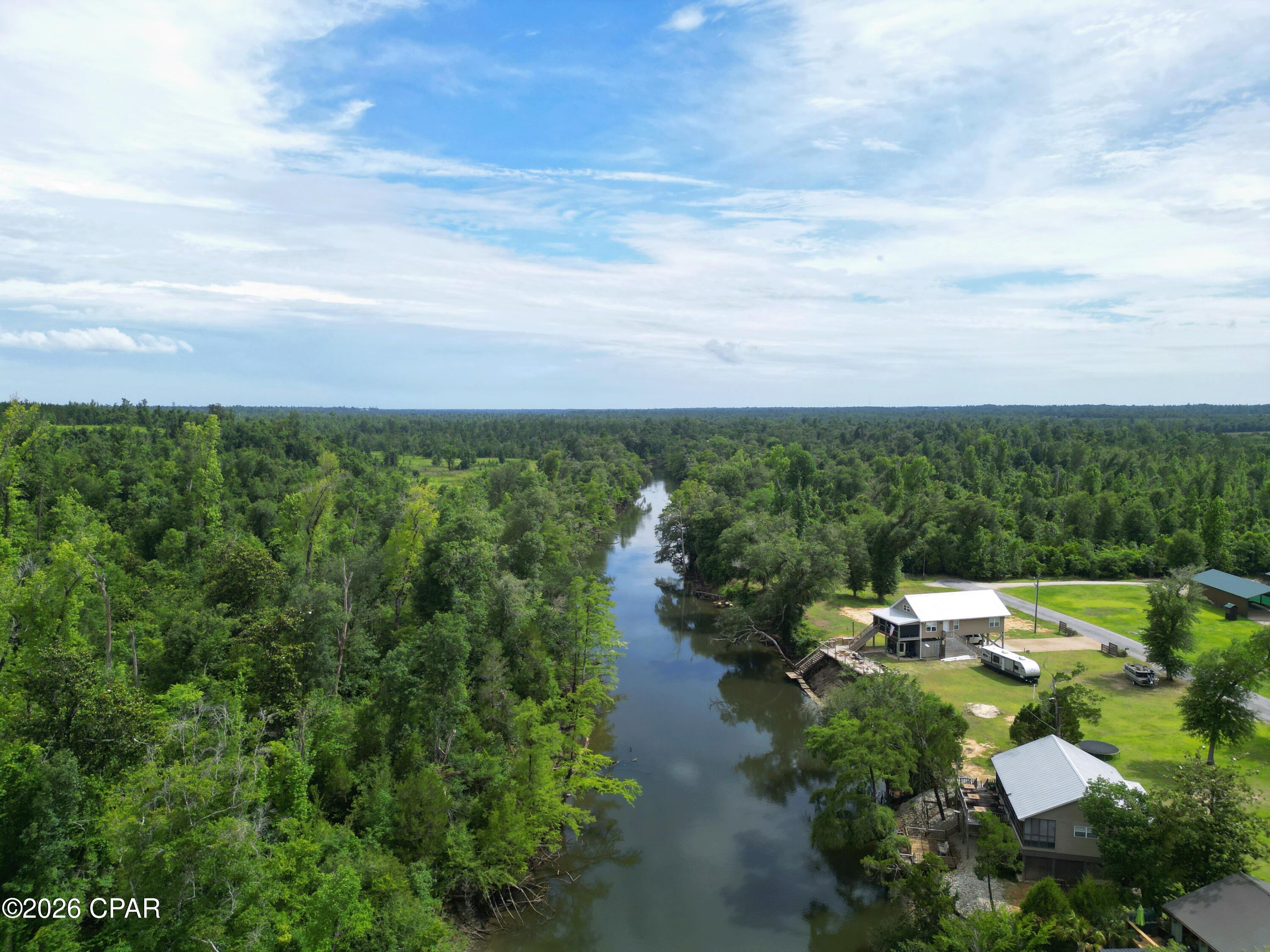 Discover the freedom of riverfront living at 20747 NW Lamb Eddy Road in Altha, Florida. Situated on approximately 0.63 acres along the beautiful Chipola River, this unique property offers the perfect place to relax, recharge, and enjoy the outdoors. With a pole barn, RV hookup, well, septic system, and direct river frontage already in place, much of the groundwork has been done so you can start enjoying the property right away.

Imagine spending your mornings with a cup of coffee overlooking the water, launching a kayak from your own river frontage, casting a fishing line from the bank, or gathering with family and friends under the spacious pole barn. Whether you're looking for a place to park your RV, spend weekends on the river, or enjoy outdoor recreation throughout the year, this property provides a variety of opportunities to make lasting memories.

Surrounded by natural beauty and scenic river views, this property offers a rare opportunity to own a special piece of waterfront property along one of North Florida's most treasured rivers. You'll appreciate the combination of waterfront access, open space, and convenience while enjoying everything the Chipola River has to offer.

Properties on the Chipola River are hard to find, especially those with existing utilities and direct access to the water. Bring your vision and create the riverfront lifestyle you've been searching for.

Don't miss your opportunity to explore everything this property has to offer.