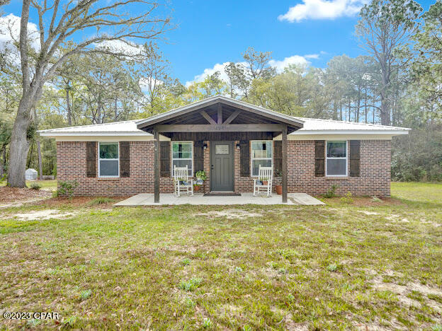 This beautiful home has been completely renovated, fronting a paved road on 1.1 acre. Updates done include recess lighting, spray foam insulation, metal roof, granite countertops, windows, custom cabinets, flooring, doors, trim, Frigidaire appliances, HVAC and electrical. Large walk-in closet in MBR. LVP flooring. Kitchen and dinette area together. Appliances included are stove, fridge, dishwasher, dryer & washer. Oversized DR window. The exterior of the home is timeless brick with shutters and a oversized front porch.  There is a covered carport and patio at the rear of the home. The backyard has 3 Hugelkulture raised garden beds with a variety of plants. Blueberry bushes, blackberry bushes and more.  Large lot adds to the privacy.  No restrictions known. City water & septic. Appt to show