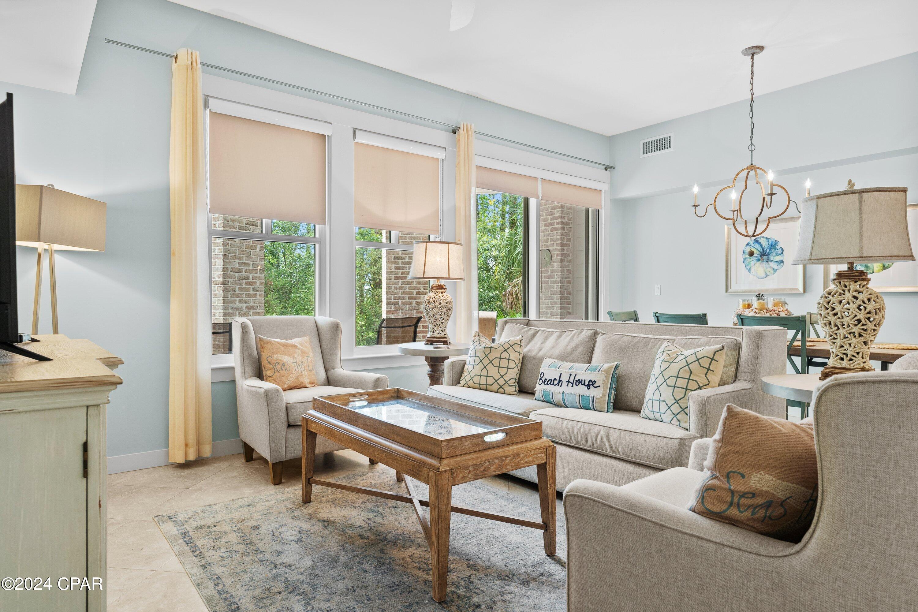 Embrace an easy coastal lifestyle with bayfront charm and built-in flexibility in this beautifully designed ground-floor 2-bedroom, 3-bath condominium, ideally positioned just a short walk from the shops, dining, and entertainment of Baytowne Wharf, with views of the Choctawhatchee Bay.

Featuring a versatile lockout floor plan, this residence offers the ability to function as a spacious 2-bedroom retreat or be separated into a 1-bedroom unit and studio, creating endless possibilities for personal use, guest accommodations, or maximizing rental potential.

Step outside onto your private covered patio and enjoy peaceful bay breezes with convenient walkout access to the lawn area. Whether you're starting the morning with coffee, winding down after a day at the beach, or heading out to explore the resort grounds, the outdoor space adds another layer of relaxed coastal living.

Inside, the thoughtfully designed interior combines modern finishes with a clean coastal feel, creating an inviting space that's equally suited for everyday comfort and entertaining.

Owners and guests enjoy access to Bahia's beautifully maintained Grand Gardens and resort-style pool, while the Village of Baytowne Wharf is just steps away, offering boutique shopping, restaurants, galleries, nightlife, and year-round events.

Whether you're looking for a full-time residence, a vacation getaway, or an investment property with flexibility built in, this condo offers an ideal combination of location, lifestyle, and function in one of the area's most sought-after resort communities. It's designed to fit the way people want to live, vacation, and invest along the Emerald Coast.