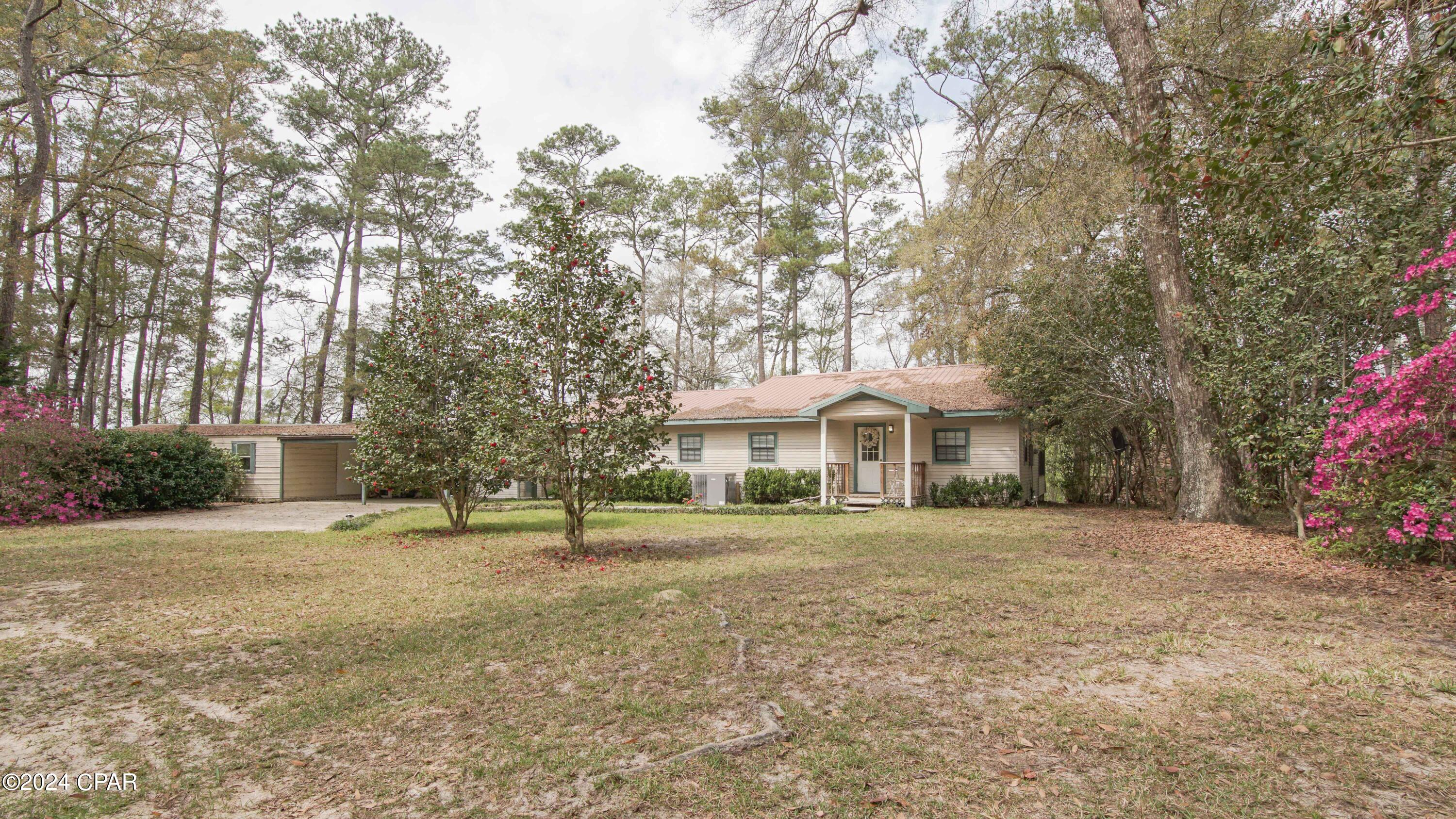 Set along the peaceful banks of Holmes Creek, this charming 2-bedroom, 2-bath creekfront home offers the perfect blend of comfort, functionality, and natural beauty on approximately 1.15± acres. Surrounded by mature trees and the soothing sounds of the water, this property provides an inviting escape ideal for full-time living or a private weekend retreat.

Inside, the home features an open and welcoming layout designed for both relaxation and entertaining. Windows showcase serene creek views, while the spacious living areas and well-appointed kitchen create a warm and inviting atmosphere.

Outdoor living is a highlight, with an expansive wooden porch and deck system that provides the perfect setting for enjoying morning coffee, dining al fresco, or taking in the tranquil waterfront scenery. The property also includes a large outbuilding with an attached carport, offering excellent storage, workspace, or hobby potential.

Combining the charm of waterfront living with modern convenience, this Holmes Creek retreat embodies the best of Northwest Florida's natural lifestyle—peaceful, private, and full of potential.