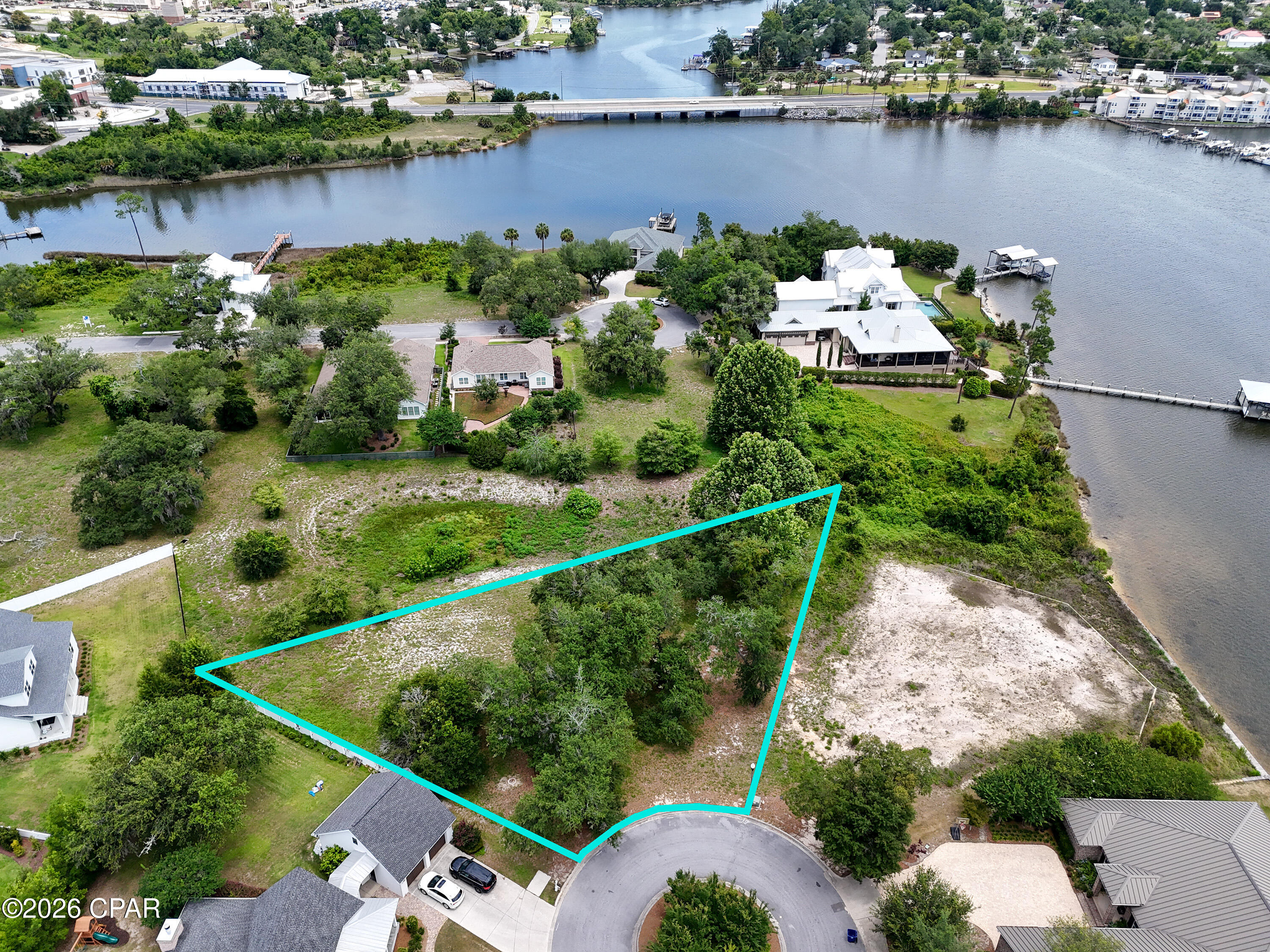 Rare opportunity to own a premier homesite with beautiful Watson Bayou views in the highly desirable Cove Pointe community. This spacious 0.48-acre lot offers the perfect setting to build your custom dream home, with ample room for outdoor living and entertaining.

Residents of Cove Pointe enjoy access to a public park, conservation area and a community day dock with navigable water leading to the bay and Gulf, making it an ideal location for boating enthusiasts and those seeking the coastal lifestyle. Architectural guidelines help preserve the neighborhood's charming coastal character and enhance the appeal of this exclusive community.

Cove Pointe is nestled within the historic Cove area of Panama City, known for its majestic oak-lined streets, waterfront properties, and scenic views. Located on a quiet cul-de-sac, 1175 Cove Pointe Drive provides both privacy and convenience, just minutes from downtown Panama City's revitalized waterfront district featuring unique shops, marinas, art galleries, restaurants, and live entertainment venues.

Enjoy easy access to local shopping, schools, healthcare facilities, and all the amenities the area has to offer. Don't miss this exceptional opportunity to create your own coastal retreat in one of Panama City's most sought-after neighborhoods.

Make Cove Pointe your coastal paradise.