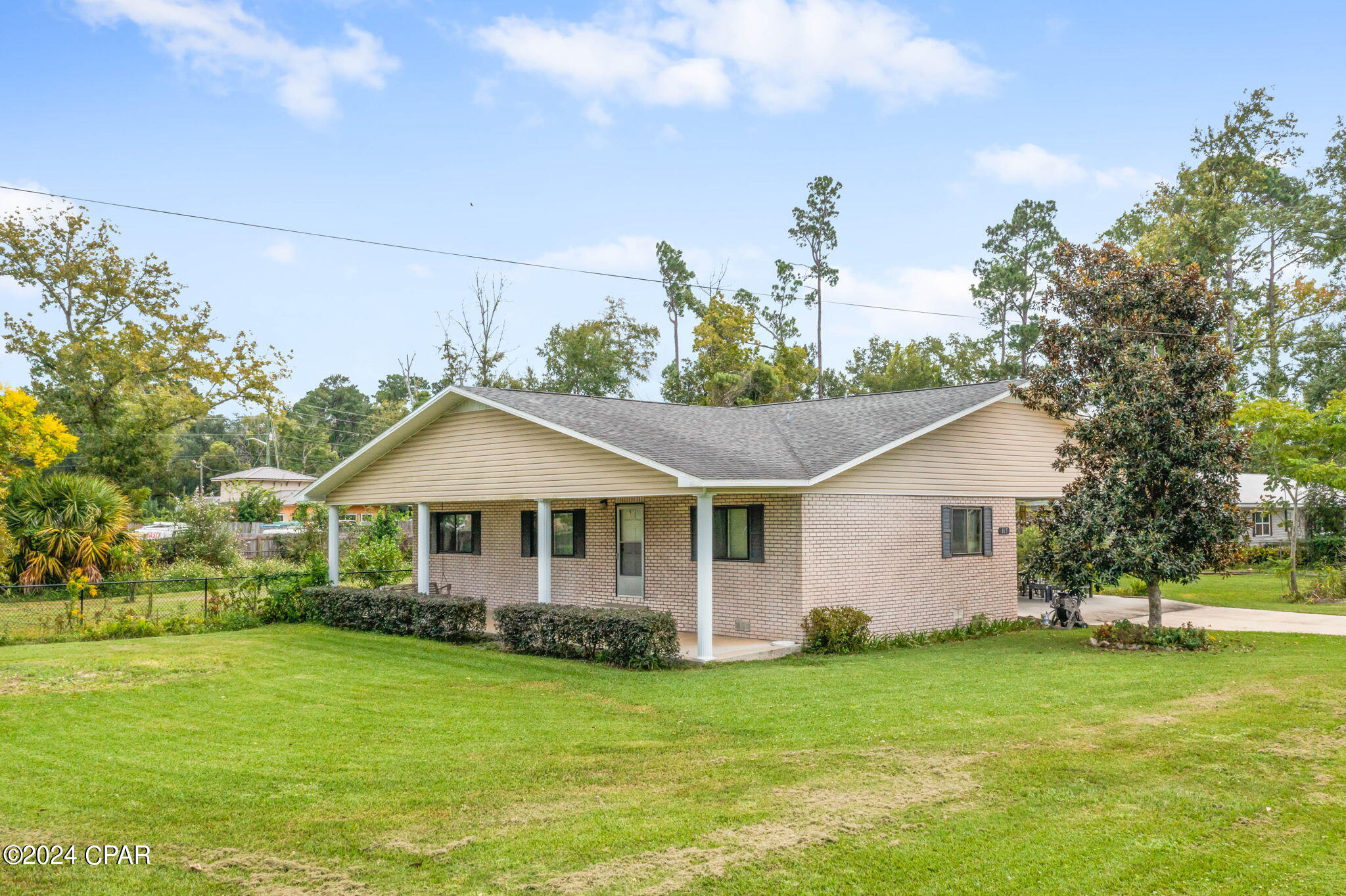 This meticulously kept double-wide mobile home boasts 3 bedrooms and 2 bathrooms, situated on a desirable city corner lot. The property features a charming sunroom, perfect for relaxation, and a convenient 2-car carport. The home is topped with a durable shingle roof and has a stucco exterior with a brick appearance for added curb appeal. The partially fenced yard is beautifully maintained and offers ample space for a small garden, should you wish to cultivate one. Additionally, there's an outbuilding for extra storage or potential workshop space. Located in a prime area, this home provides both comfort and convenience. Don't miss out on this wonderful opportunity, call today to schedule your personal viewing!