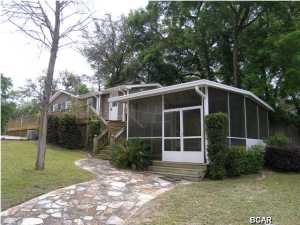 Waterfront on Burnt Mill Creek - 2 Docks - 2 large porches - 3 miles from the entrance to the Airport - Amazing views! Burnt Mill Creek flows directly to North Bay then in St. Andrews Bay to the Gulf. Some of the best Bay fishing in the state. Two super large screened in porches make this property a true oasis! This property is absolutely stunning. Lots of money has gone into the porches, seawalls, docks. outdoor shower and the other improvements on the property. The house has been remodeled inside and is in good condition. The property consists the house, the two docks, two large screened in porches, the little creek, the seawalls on the right and on the water and all of the grasses area between. It is a beautiful property and is a must see for yourself.