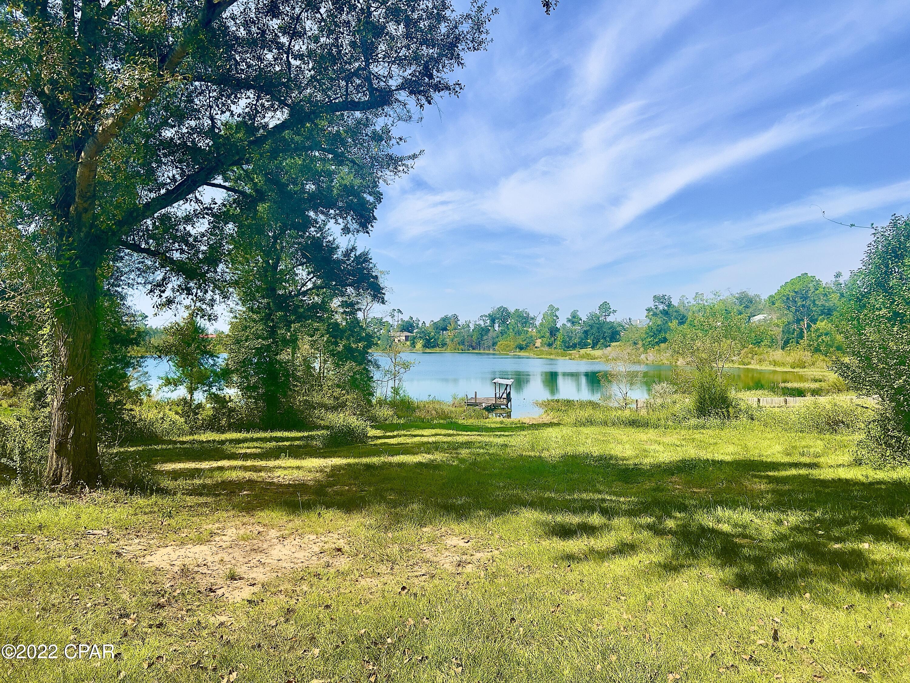 A diamond in the rough, This home is located in northern Calhoun County overlooking White Pond, A beautiful Florida spring fed lake.  Needing a little TLC, This home has the potential to be your perfect forever home.  The Florida room overlooks the lake and is the perfect place for you to enjoy your morning coffee.  The lake is known for it's large bass and makes a great place to fish with a spot to launch your boat.  This house is set in the hillside making it much easier and cheaper to heat and cool giving you a natural insolation.  Allow yourself to be embraced in the ambience and potential in this home.