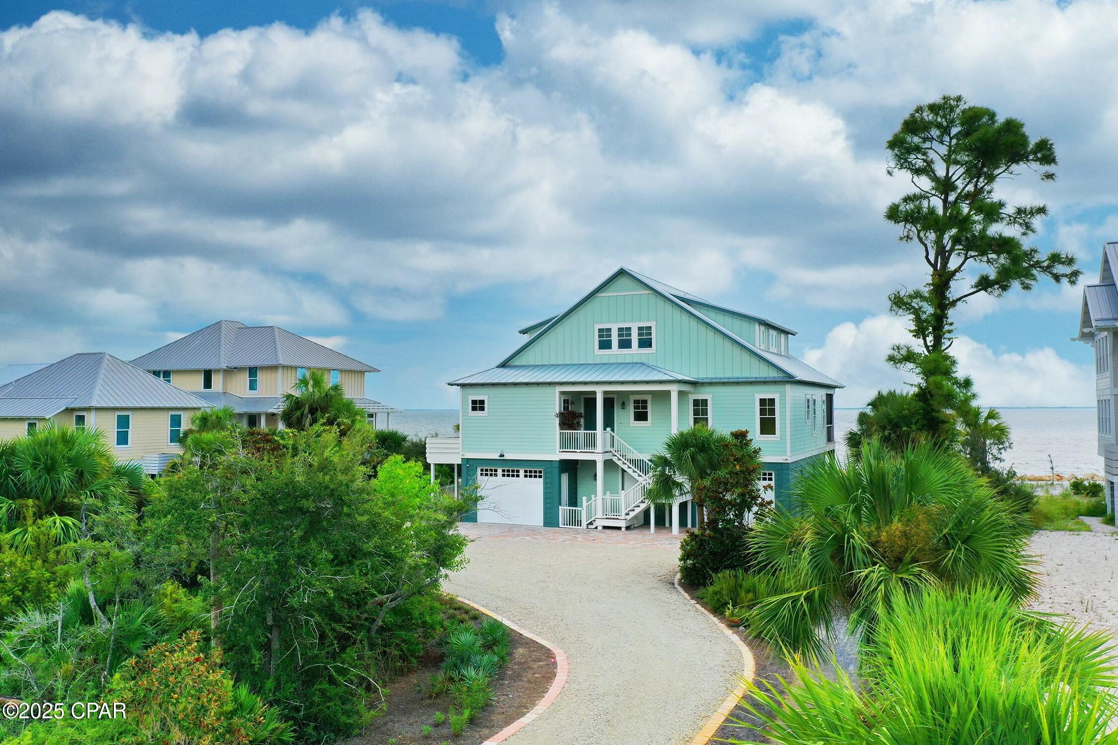 CURRENTLY UNDER CONTRACT, SELLER WILL CONSIDER BACKUP OFFERS
Experience Unmatched Coastal Luxury at this Unique Beachfront Retreat. Nestled within the exclusive gates of WindMark Beach, a premier beachfront community developed by the esteemed St. Joe Company, this custom-built home is the ultimate dream retreat or investment opportunity. Upon entering, you're immediately captivated by panoramic water views that stretch across the horizon, framing the large screened porch and shimmering pool— the true heart of this magnificent residence. This idyllic space is perfect for soaking in sunny days and enjoying starlit evenings, creating memories that will last a lifetime. The living room, featuring a coffered ceiling and a warm, inviting fireplace, exudes cozy sophistication. Designed with entertaining in mind, the open-concept layout seamlessly connects to the gourmet kitchen, which boasts a striking tile backsplash, top-of-the-line GE Monogram Series appliances, and oversized island. Two private guest suites on the main level ensure comfort and privacy for visitors. Ascending to the upper level, you'll discover a luxurious master suite that serves as a personal sanctuary, complete with a second fireplace and a private balcony offering sweeping bay views. The spa-inspired master bathroom elevates relaxation promising a serene escape. A versatile fourth bedroom offers the flexibility to serve as a gym or office, while an additional sitting area can easily be transformed into a bunk space and potential a fourth bathroom, with convenient access provided by an elevator that services all three floors. The property's thoughtful design extends to the planned carriage house, offering future expansion opportunities. Below the home, a spacious garage provides ample room for cars, a golf cart, beach toys, and more. Professionally landscaped grounds surround the residence, enhancing the serene setting. Windmark offers a resort like lifestyle featuring fine dining, specialty shops, fitness center, dog park, and golf cart friendly paths.