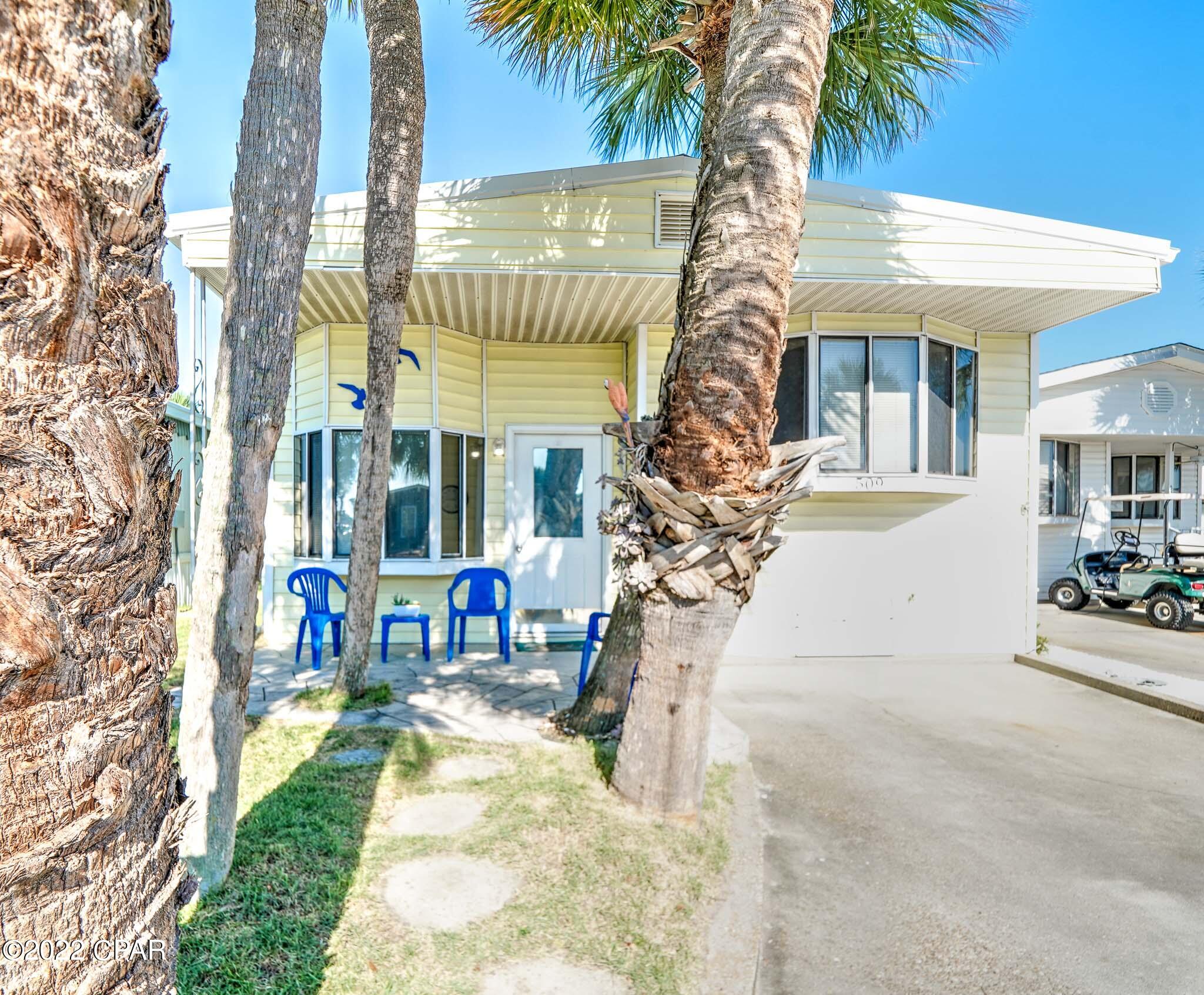 Unique opportunity to own in Venture Out. Check out this great 2 bedroom, 2 bath home just steps from the beach! This home is super close to the front of the resort making it very convenient to the beach. tennis courts and extra parking. Seller recently added: new roof, new drywall, new floors and more.  Enjoy afternoons on the fabulous front porch that offers plenty of room for grilling and relaxing after a long day on beach. It doesn't get better than this! Venture Out is a golf cart community that has 300' on the beautiful pristine beaches of the Gulf of Mexico and 1,000' on the Grand Lagoon. Venture Out has something for everyone. With two pools (one heated), fishing pier, boat ramp, mini golf, children's playground and much more.
