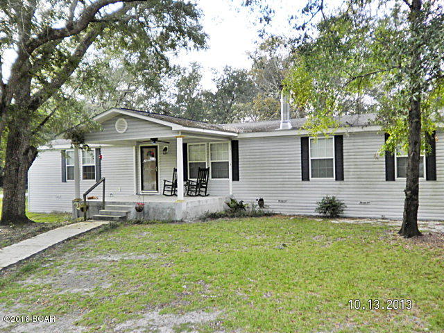 Very nice mobile home on a paved road in the city limits of Grand Ridge close to school, this home features an open floor plan with large living room with vaulted ceilings and stone wood burning fireplace, master bedroom has a large master bath with double sinks, garden tub with jets and a separate shower, large walk-in closet, kitchen has a counter top stove replaced in September, built in oven and microwave, side by side ref, stainless steel sink with garbage disposal and an island, with plenty of room for a large dining table, the other two bedrooms are nice size also, laundry room, large concrete front porch with Spray-crete diamond design in it with concrete walkway to parking pad in front. Back has a metal two car carport and a metal storage shed,the A/C unit is only 2 years old, the front yard has a sprinkler system, lots of oak shade trees and good neighborhood. Call agent today to view this home.