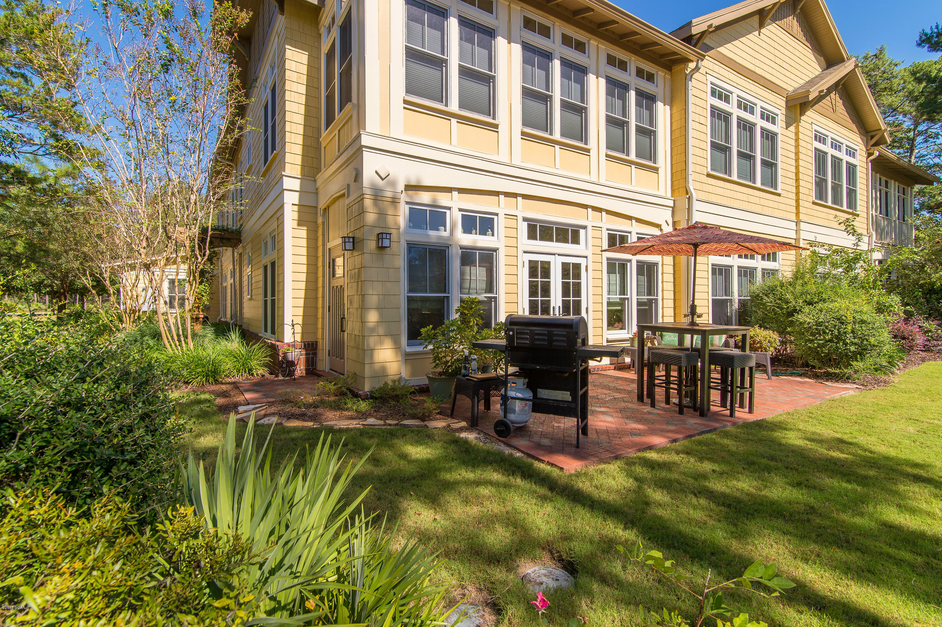 Your best--& possibly last--opportunity to own Wild Heron at this price! Gorgeous GROUND-LEVEL 3/2 condo in Tin Cup Ct. (next to Sharks Tooth Golf Club) with over 2000 sqft, oversized 2-car garage,& private patio directly accessing the pool area. This Coastal Craftsman-style home boasts 10 ft ceilings w/ beautiful crown molding & millwork, a split-bedroom plan, gorgeous hardwood flooring, brand-new carpet & paint, custom built-in shelving, granite countertops & <2 yr old stainless appliances, and a sun-drenched Florida Room overlooking the patio. All the comforts of home-- if your home includes a Golf Course designed by Greg Norman & world-class amenities like the Prospect Point Boat House, Health Club, Neighborhood Pool & playground, & Fire Pit for roasting marshmallows on chilly nights. Wild Heron is a private, gated community perfectly situated just off the beaten path, but ideally convenient to both the upscale laid-back lifestyle of 30A & S Walton County and the shopping & entertainment at Pier Park in Panama City Beach. The entire Wild Heron development celebrates Coastal Florida with architechtural elements that emphasize the natural beauty of the area. Numerous trails meander throughout the property leading to views of spectacular sawgrass bayous or cypress & lillypad dune lakes-- all carefully landscaped and maintained for you. So, don't let this chance to own the perfect Florida lifestyle pass you by; make your appointment today before this one gets away.