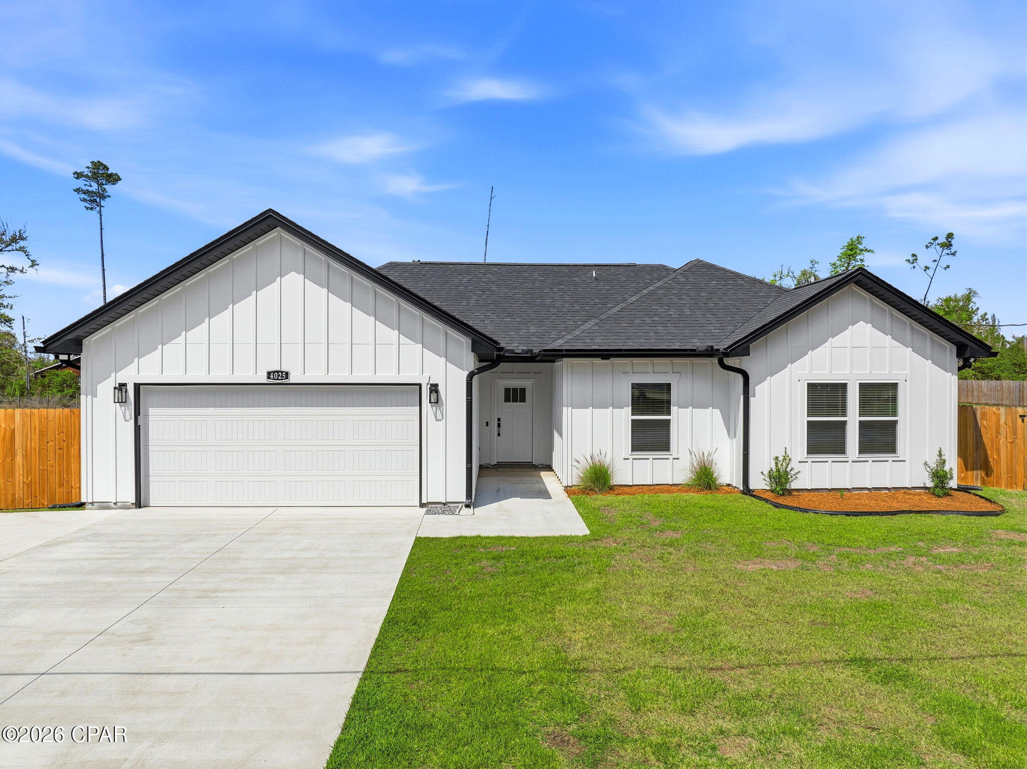 Under Contract - Taking Backups. Welcome to 4025 Kirkpatrick Road, a beautifully crafted 2025 built single-family home offering the perfect blend of modern design and peaceful country living, just minutes from Lynn Haven conveniences.

Situated on 2.62 fully fenced acres, this home is thoughtfully designed with an open-concept layout, 9-foot ceilings, and tray ceilings in the living room and master bedroom that create a bright, spacious feel. The interior is finished with recessed lighting and tasteful black hardware throughout, giving the home a clean, contemporary look.

The kitchen is a standout feature, complete with shaker-style cabinetry, quartz countertops, and stainless steel appliances, ideal for both everyday living and entertaining.

The primary suite offers a private retreat with a walk-in shower featuring a sleek glass enclosure, continuing the home's modern aesthetic.

Step outside to enjoy a covered back porch, overlooking your expansive property. The outdoor space is extended with a concrete patio, perfect for hosting or relaxing while taking in the peaceful surroundings.

This property is fully fenced with upgraded horse-safe fencing and includes a newly constructed barn/livestock structure, making it ideal for equestrian use or hobby farming. A pond adds both character and functionality to the land.

Additional features include a 2-car garage, durable Hardie board siding, gutters, and a shingle roof.

If you're looking for new construction with acreage, privacy, and flexibility, all within close proximity to town, this property delivers.