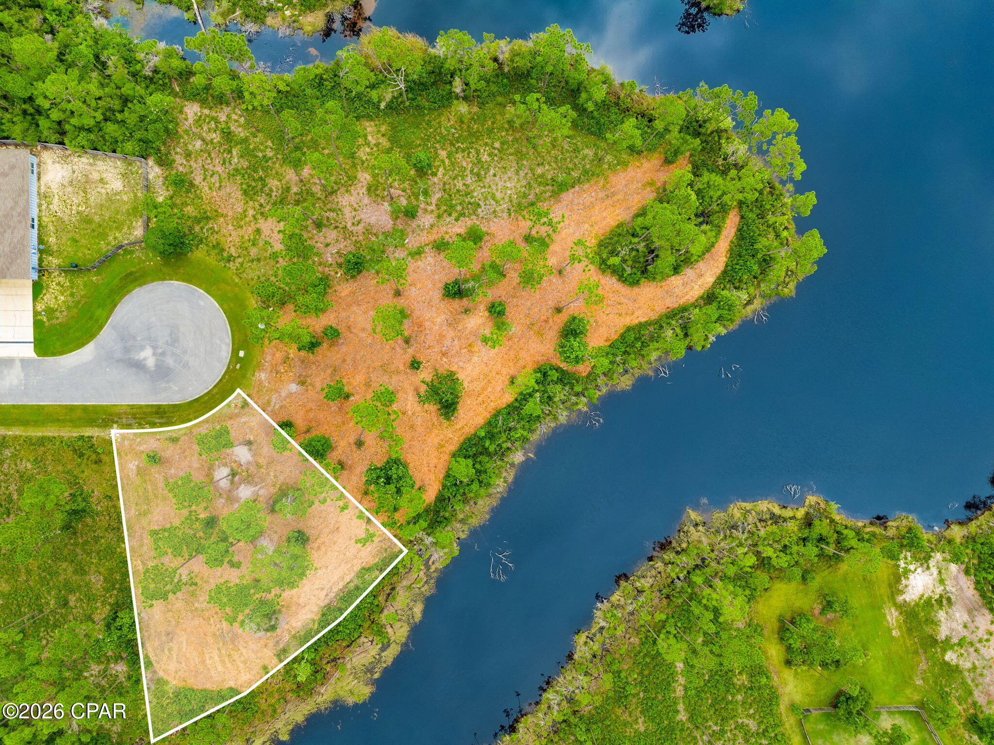 Nestled within the private gated waterfront community of Laird Point, this beautiful waterfront homesite at 801 Buoy Court offers approximately 177 feet of lake frontage, creating the perfect backdrop for your custom-built dream home. Surrounded by peaceful natural beauty, this property provides an exceptional opportunity to enjoy the quiet lifestyle that makes Laird Point so desirable.

The community's freshwater lake is thoughtfully maintained to preserve its tranquil setting. Waterfront lots are non-dockable, and gas-powered boats are prohibited, making it ideal for kayaking, canoeing, paddleboarding, fishing, or simply enjoying the calm water views from your own backyard.

With ample space to design the home you've always envisioned, you'll have plenty of room for outdoor entertaining, a pool, or expansive living areas. For those seeking even more possibilities, the adjacent lot at 800 Buoy Court is also available for purchase. The seller also has house plans available, offering the opportunity to create a larger homesite or multi-lot estate.

To make the building process even easier, the seller has a current survey and elevation certificate available for the buyer.

Laird Point offers an outstanding coastal lifestyle with city utilities, underground electric, ribbon-curbed streets, pickleball courts, and dedicated RV and boat storage. Residents also enjoy easy access to East Bay, known throughout the Florida Panhandle for exceptional boating and world-class redfish and speckled trout fishing.

Conveniently located just minutes from Tyndall Air Force Base, Mexico Beach, Port St. Joe, Panama City, and Panama City Beach, you'll enjoy the perfect balance of peaceful waterfront living with nearby shopping, dining, entertainment, and Gulf Coast beaches.

Whether you're planning to build your forever home or invest in one of the area's fastest-growing waterfront communities, 801 Buoy Court offers an incredible opportunity to make your vision a reality.

Schedule your private tour today and experience everything Laird Point has to offer.