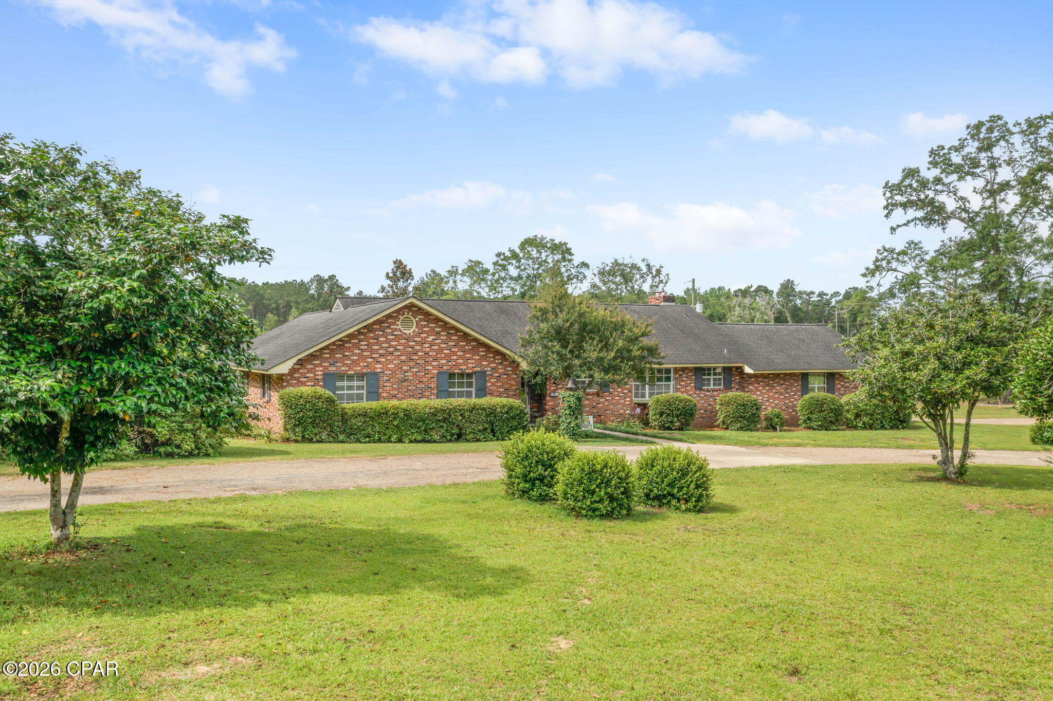 Welcome home to peaceful country living on approximately 2+/- acres, offering the perfect blend of privacy and convenience just minutes from town. This spacious 4 bedroom, 2.5 bath brick home offers a blend of charm, comfort, and room to spread out both inside and out. From the moment you arrive, the circular driveway, mature landscaping, and inviting front entry create a welcoming first impression. Inside, you'll find beautiful pine flooring, crown molding, and generously sized living spaces designed for everyday living and entertaining. The large dining room features decorative beams and plenty of space for gatherings, while the kitchen offers an abundance of cabinetry, ample counter space, and views overlooking the property. The spacious primary suite features a private attached bath, while the additional bedrooms provide flexibility for family, guests, or office space. Step outside and enjoy the open backyard setting complete with an above-ground pool, plenty of room for outdoor activities, and a detached workshop/storage building. The acreage offers privacy while still providing space for gardening, hobbies, or simply enjoying the peaceful surroundings.