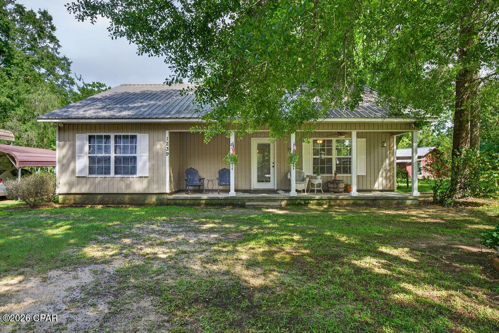 Welcome to 1239 Holley Avenue, a charming 2-bedroom, 2-bathroom home located within the city limits of Chipley. This home features an inviting open-concept living area that flows easily into the kitchen, where you'll find beautiful solid oak cabinets offering both character and storage. The master bedroom includes a walk-in closet, providing added convenience and functionality. A durable metal roof adds peace of mind, while the fenced-in backyard creates a great space for pets, outdoor enjoyment, or entertaining. The property also includes a 12x20 storage building and two detached carports, offering plenty of room for parking, tools, lawn equipment, or extra storage. Conveniently located close to town, this home is a great opportunity for comfortable living in the heart of Chipley.
