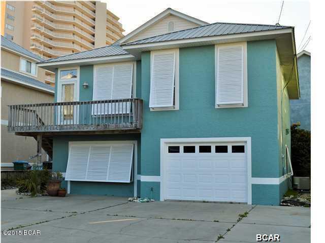 Superb location, south of Thomas Drive on a private street. Just steps to the beach with deeded access. Inverted floorplan with kitchen, living, dining, laundry, master suite and one guest bedroom on the second floor. First floor has two additional bedrooms, bonus den, full bath and over-sized one car garage with extra storage. This house is perfectly suited for beach living with stained concrete floors on the first level and hardwood floors on the second. New stainless appliances in the kitchen complete the package. Very few long-term rentals this close to the sand.