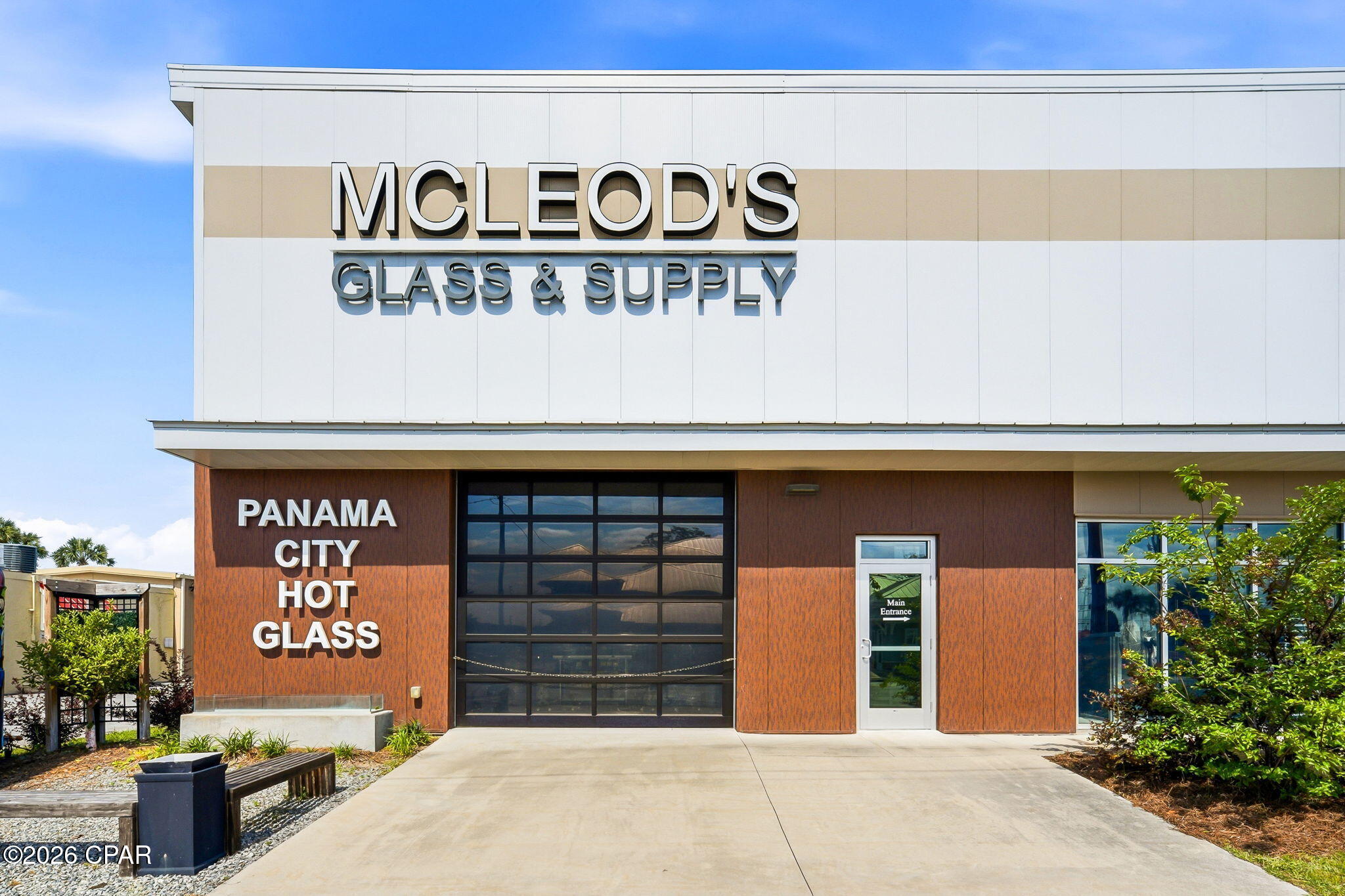 Strategically located in Panama City along one of the area's growing commercial corridors, this brand-new commercial property at 1331 Harrison Ave offers approximately 11,171 square feet of versatile showroom, warehouse, and office space designed to support a wide variety of business operations. Combining a polished customer-facing showroom, expansive warehouse with mezzanine storage, dedicated office and reception areas, and exceptional building infrastructure, this property is ideally suited for owner-users, fabricators, distributors, light industrial operators, automotive or service businesses, or investors looking for a turn-key commercial asset with rare quality of construction and operational flexibility.
The building features a 7,134 SF warehouse with soaring ceilings approaching 21 feet, providing outstanding vertical storage capacity, room for equipment, shelving, racking, or specialized fabrication operations. The open-span warehouse layout accommodates a variety of industrial or commercial uses, with sealed concrete floors built to handle heavy equipment loads. A 1,391 SF mezzanine adds substantial usable square footage above, perfect for organized inventory storage, supplies, archives, or workspace expansion without sacrificing warehouse floor area below.
At the front of the building, a professionally finished 1,153 SF showroom with stained and sealed concrete floors, acoustic drop ceilings, and LED pendant lighting creates a striking customer-facing environment ideal for retail displays, product showcases, client meetings, or design-forward office buildout. Adjacent spaces include a dedicated reception, private office, filing area, vacuum room, and ADA-compliant restrooms -- providing a complete, ready-to-occupy front-of-house operation. A major value-add of the property is the building's premium Kingspan® insulated metal wall and roof panel envelope, delivering exceptional thermal performance, energy efficiency, and a clean modern architectural finish that is rare to find in this market and difficult to replicate at today's construction costs.
The property is supported by serious infrastructure built for industrial and commercial demand, including a 600-amp, 240/120V 3-phase electrical service with roughly 70% spare capacity for additional equipment. The 24,000 SF site features ADA-accessible parking, on-street parking, professional landscaping, and durable concrete drives, all engineered to current Florida Building Code with hurricane-rated structural design. Whether you're relocating an existing operation, launching a new business headquarters, or seeking a high-quality commercial investment, 1331 Harrison Ave delivers size, functionality, premium construction, and long-term potential in a strategic Panama City location.