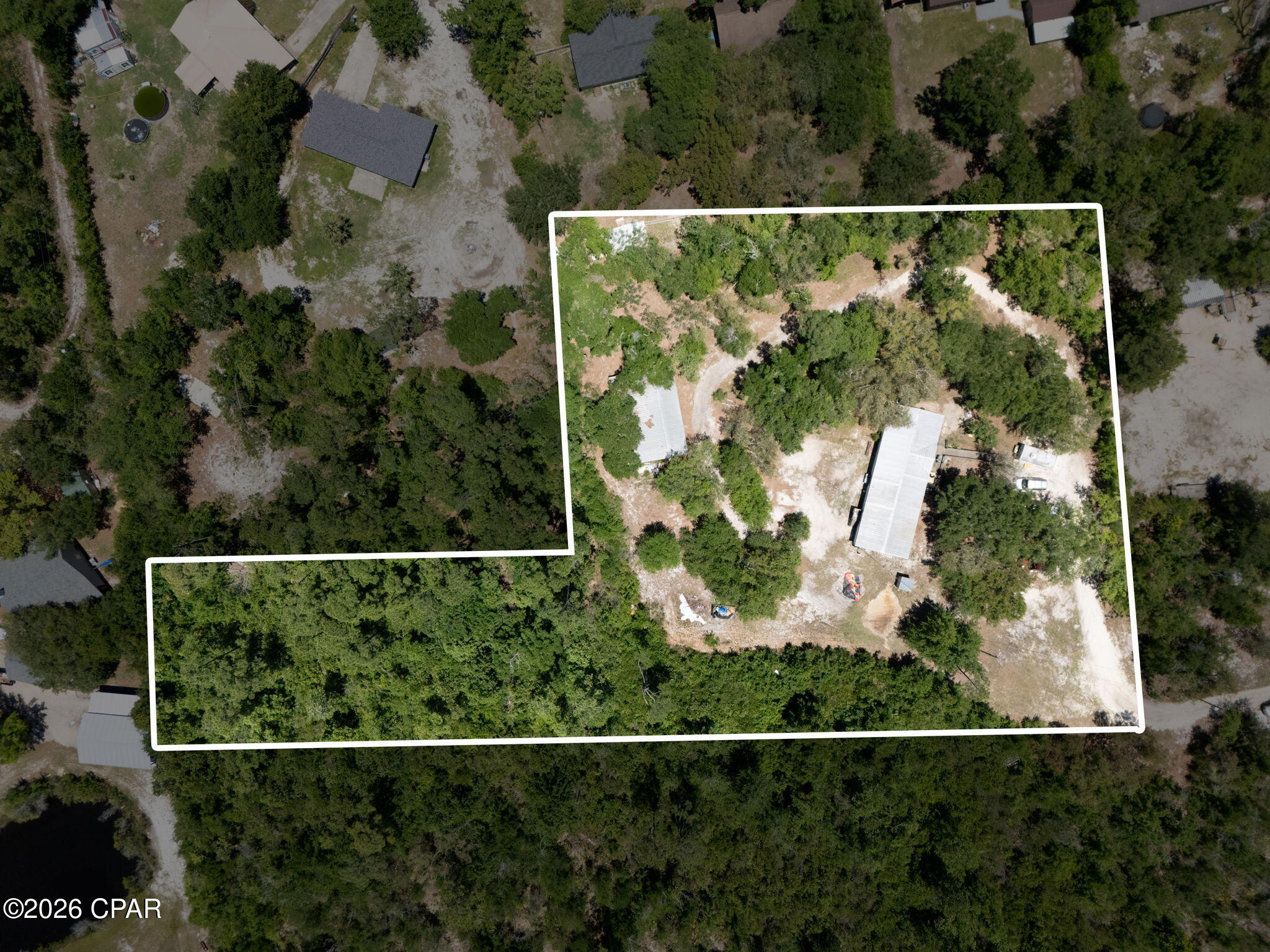 Situated on 2.5 expansive acres in desirable Southport, 8325 Resota Beach Dr offers endless potential with plenty of room to create your ideal homestead, investment property, or private retreat. This large 4-bedroom home also features valuable flex space perfect for a home office, playroom, guest area, or additional living space to fit your needs. The backyard features a 32x48 Pole barn with attached room and has electric & water already connected! With spacious interiors and a prime location near boat ramps, shopping, dining, and Panama City amenities, this property combines privacy with convenience. The bathroom has been gutted and is ready to be completed to your personal style, offering a great opportunity to add value and customize. With acreage, size, and versatility, this property is packed with possibilities for the right buyer.