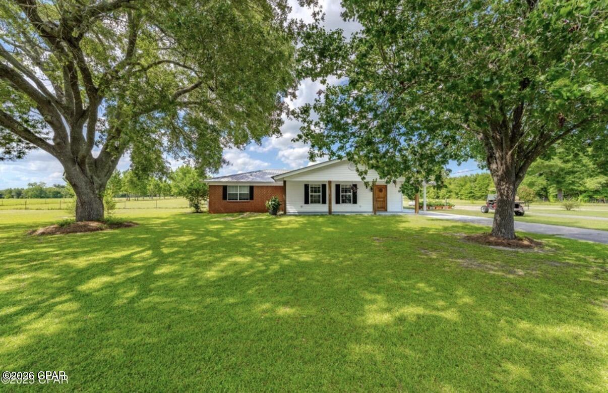 Welcome to this newly renovated, charming 3 bedroom, 2 bathroom home nestled on over 5 acres of high, dry, and flat land in the desirable Dellwood area, just off Blue Springs Rd and Hwy 69-the perfect location for peaceful country living with easy access to town! Step inside to find a massive living area and an open kitchen that's perfect for entertaining or relaxing with the family. The primary bedroom suite is a true retreat with a gigantic closet and bathroom that feels more like a luxury escape. Enjoy evenings on the screened porch under the shade of mature trees, or take advantage of the large attached shop with roll-up door-perfect for tools, toys, or projects. Need extra space? There's an attached bonus family/playroom complete with a second full-size kitchen-ideal for hosting, multi-generational living, or even your dream hobby space. Just behind the home is a beautiful above ground pool with deck built just for this pool. This is the Dellwood property you've been waiting for-privacy, functionality, and room to grow.