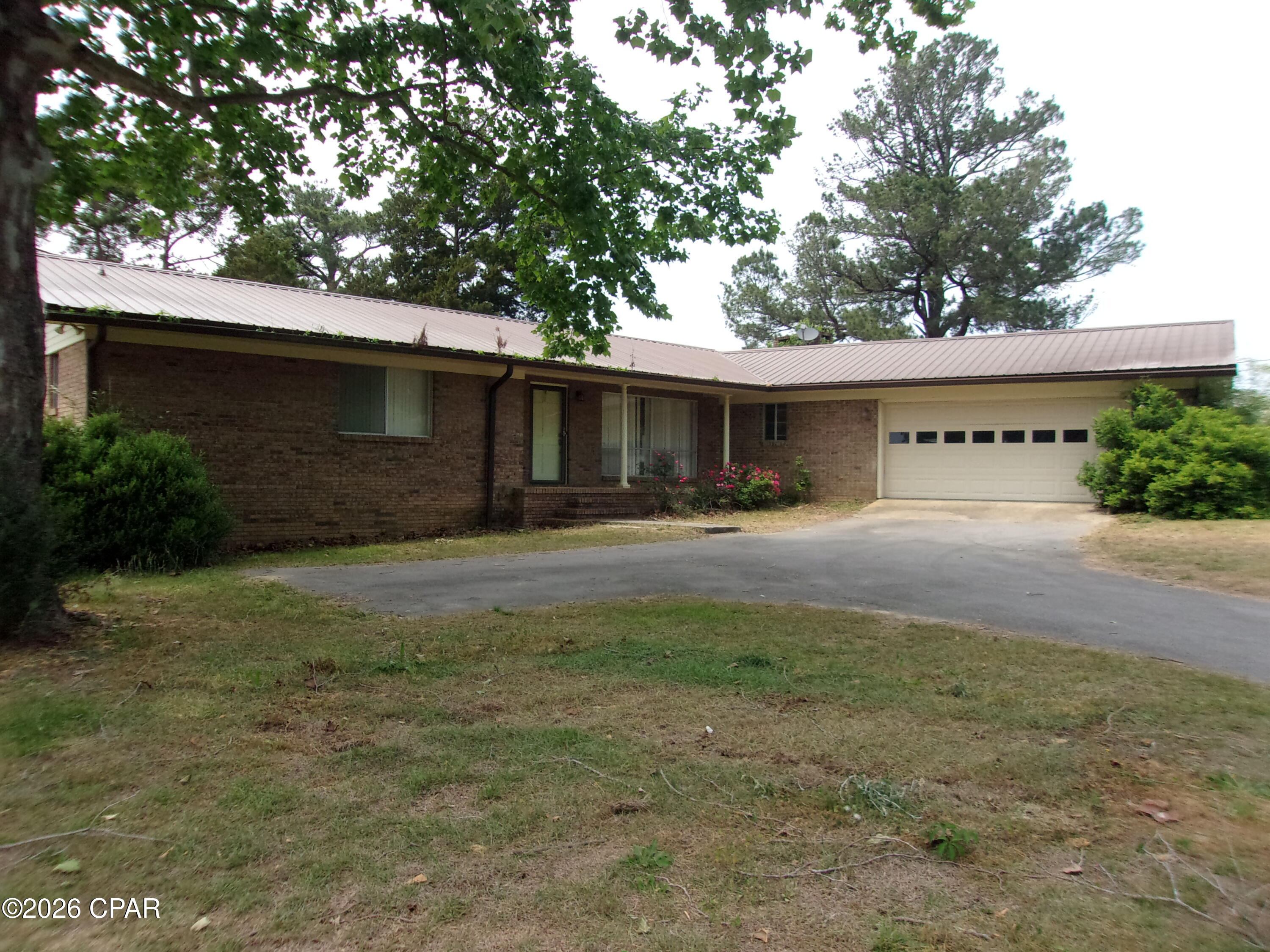 Fixer Upper. Discover the exciting potential in this 3-bedroom, 2.5-bath fixer-upper located in the desirable Dogwood Lakes subdivision. Set on a quiet street, this home features a spacious living room with a cozy fireplace, a two-car garage, and a backyard that backs directly onto the fairways of Dogwood Lakes Golf Course. Just a short walk to the neighborhood lake for fishing, and only a 3-minute drive to Wrights Creek for fishing and swimming. Conveniently located just one hour from the stunning sugar-white beaches of Panama City Beach. With some updates and personal touches, this property offers tremendous opportunity to create your ideal home in a fantastic location surrounded by recreation and natural beauty.