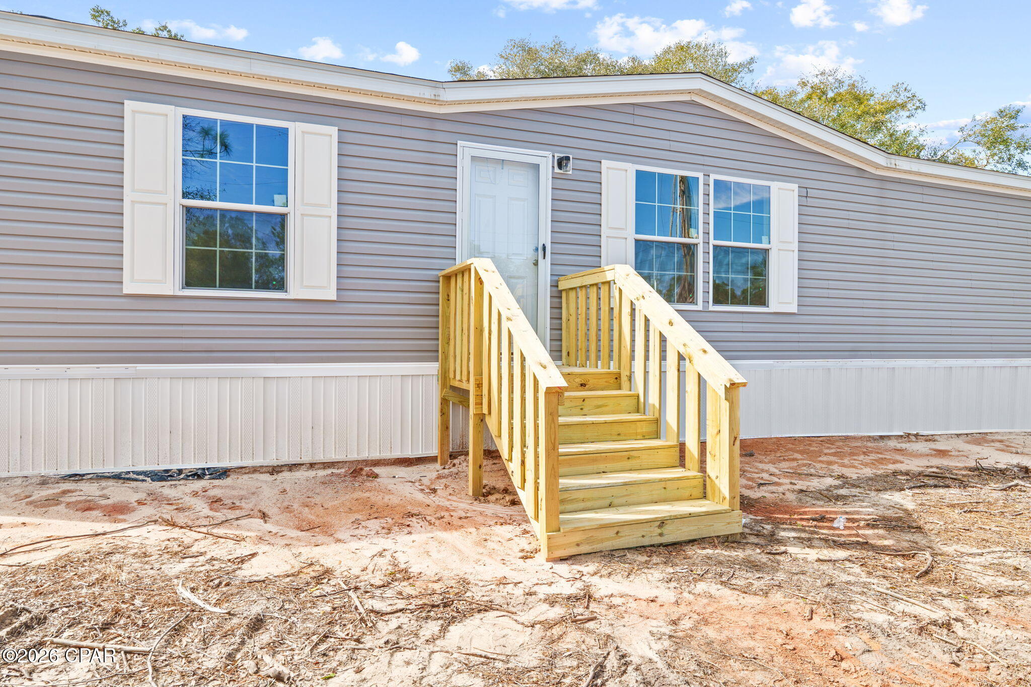 Welcome to this BRAND NEW 2026 Model, 3 bedroom/2 bath manufactured home where trendy, color schemes and finishes meet a highly functional design. This home is apart of the Paradise Lakes Community, so you'll have access to the lakes, boat ramp, clubhouse, & everything else Paradise Lakes has to offer! The open-concept layout flows perfectly while the split-bedroom floorplan offers privacy and functionality for everyone at home! You'll love the spacious kitchen featuring stainless steel appliances, a nicely sized island, and ample cabinetry. The kitchen is open to the living and dining space making it suitable for large gatherings with your loved ones! The laundry room provides additional storage and extra space you'll actually enjoy using. As you enter the primary suite, you'll immediately enjoy the sq footage of this huge room! The primary bath offers a double vanity, huge two-person shower, and a large walk in closet. This new home sits on half an acre just waiting for you to add your personal touches after you call this place HOME! The front and backyard is level and clear directly around the home making it the perfect canvas for your outdoor storage needs. Location is key and this house is located about 2.5 miles (7 minutes) from Hwy 77. You'll have the ''country'' feel without being too far from all the attractions that Chipley, Lynn Haven, and Panama City have to offer! Come check it out!