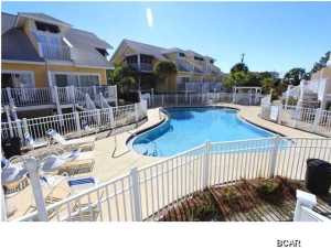 Just listed is an immaculate, never before rented oversized 2BR townhouse on the beachside of Hwy 98 in Mexico Beach. With multiple decks, storage, and a covered garage, these are the largest 2BR townhouses or condos in Mexico Beach with 1,922 total sq ft. Oceanside Village is a very desirable and well laid out townhouse development located steps to the beach, pier, Mexico Beach Marina, Tommy T's, Shell Shack and 40th St. Pizzeria. The layout is very spacious and provides comfortable sleeping for 10. The open kitchen/dining/living area flow well and open up to the deck overlooking one of the nicest pool areas in Mexico Beach. The master bedroom/bath is very roomy and has a private Gulf view deck. This home is well furnished & equipped & includes everything with the exception of a