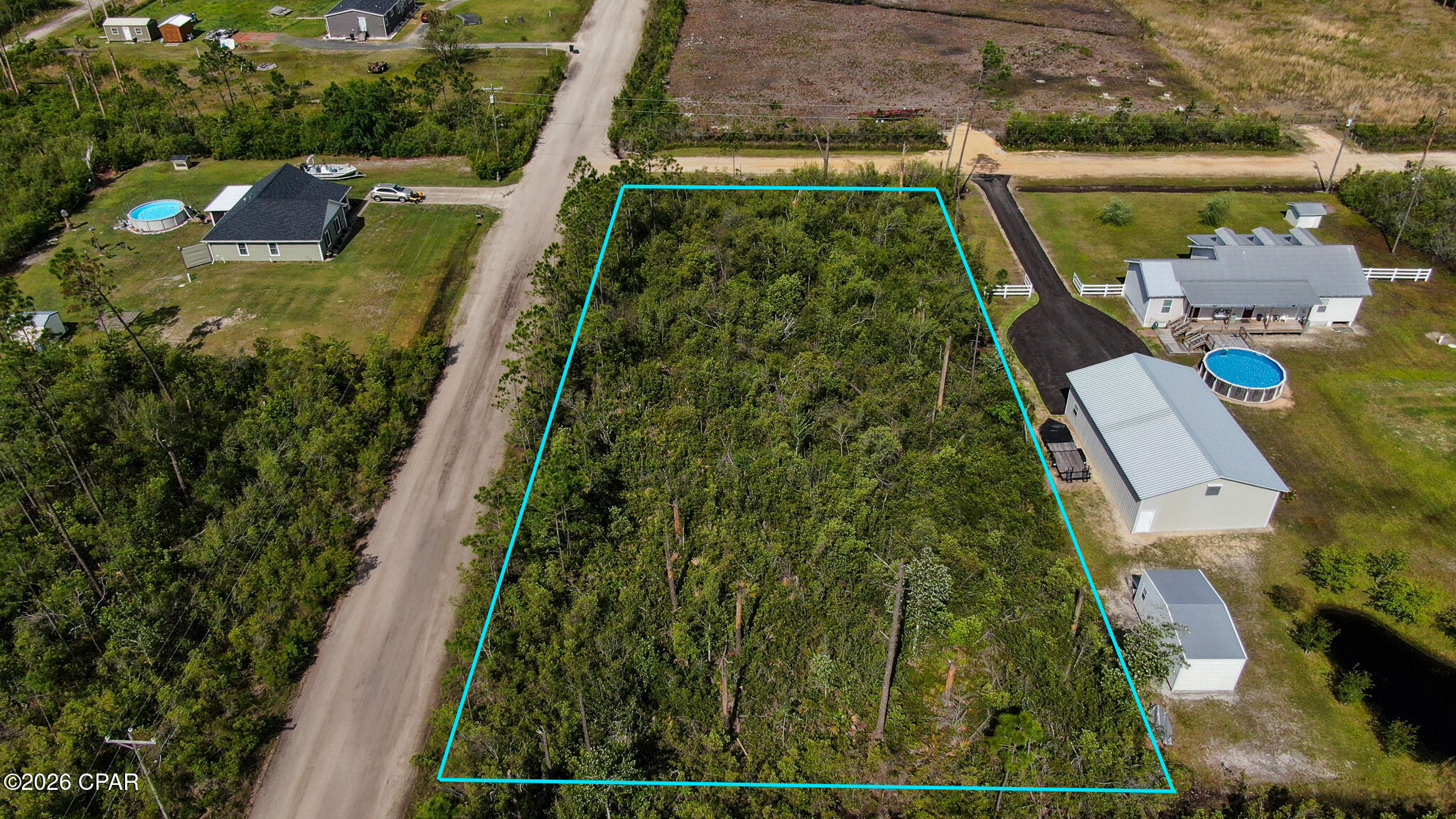 Property is raw land, uncleared. It's a 1 acre corner lot with electrical service at the street. The property has no mailing address. Next door neighbor address is 2201 BJ Drive.  Buyer should verify all zoning, measurements and land uses plus all other information deemed important.  Property is in a flood zone.