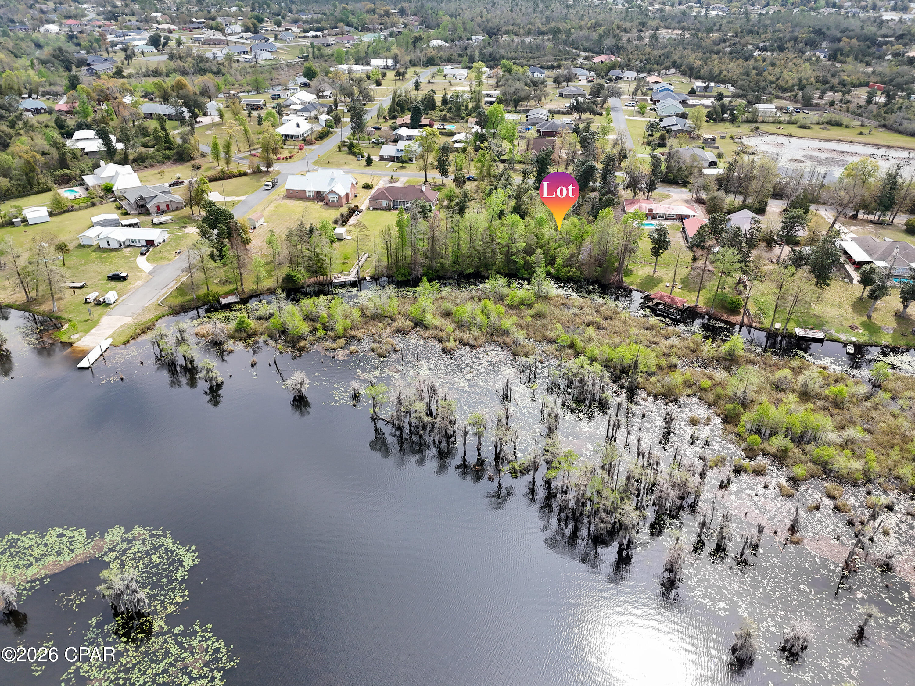 Build your dream retreat on this exceptional 0.57-acre canal-front homesite offering 100 feet of water frontage with direct access to Deer Point Lake. With serene water views & ample space to design your ideal residence, this property provides the perfect setting for a private dock, pool, workshop, or additional outdoor living features. Deer Point Lake is a 5,000-acre freshwater reservoir, formed by damming Econfina Creek, Bear Creek, and Cedar Creek, and is widely known for its outstanding fishing, boating, kayaking, and paddle boarding. Whether you envision a full-time residence or a peaceful weekend escape, this location delivers both recreation & tranquility. Conveniently situated approx 150 yards from the public boat ramp at Cedar Creek, water access is effortless. For those seeking even more space & expanded waterfront, the adjacent lot is also available, presenting a rare opportunity to own a combined 1.15 acres with 200 feet of canal frontage. This prime homesite makes an exceptional canvas for your waterfront vision with direct lake access, generous acreage, and expansion potential.