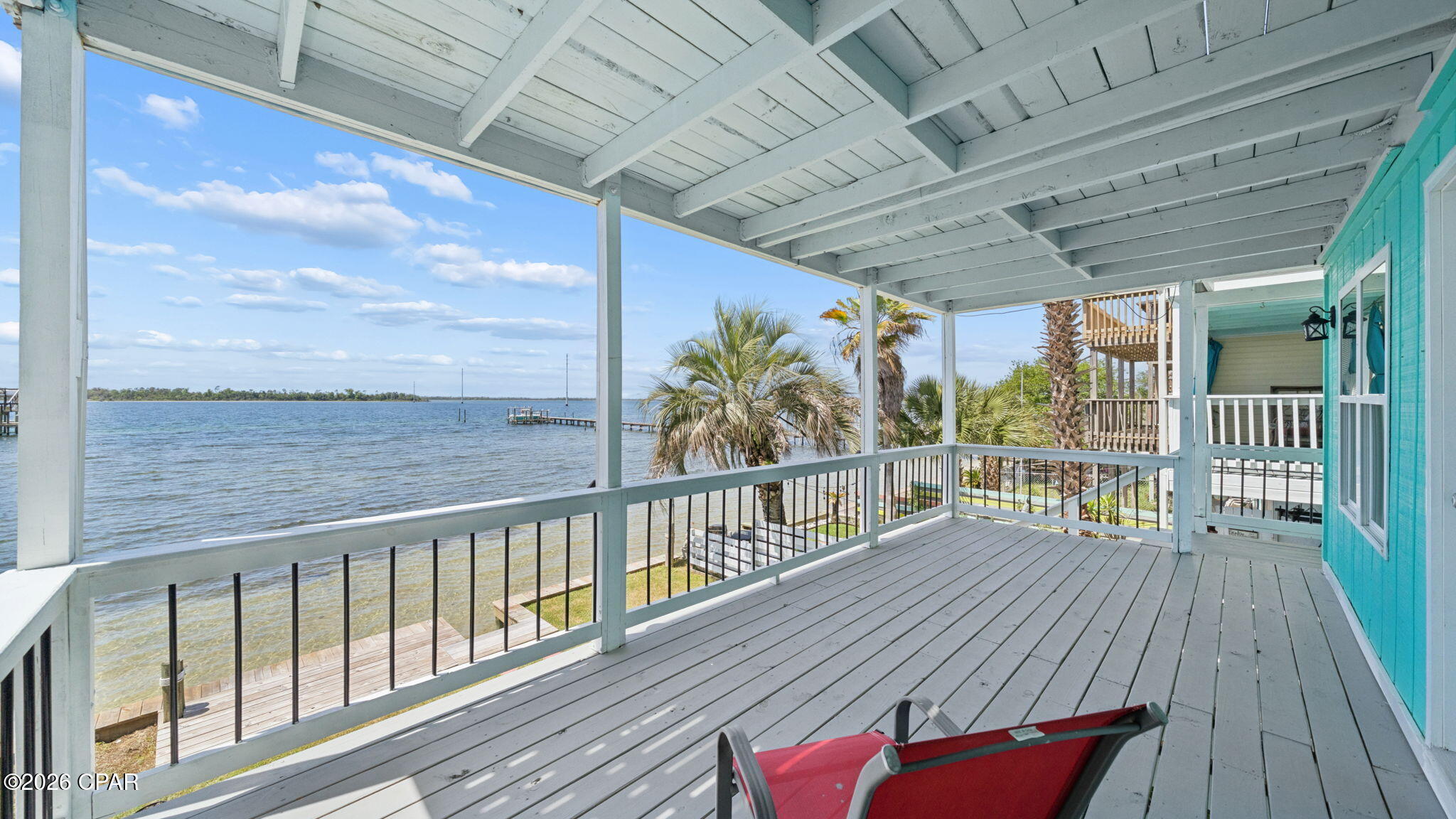 UNDER CONTRACT WITH CONTINGENCIES; SELLER ACCEPTING BACKUP OFFERS.

One of the best-priced bayfront properties with direct Gulf access in Bay County, this beautifully updated three-story East Bay townhome delivers deep-water access, stunning views, and exceptional versatility--including a fully independent 1 bed / 1 bath ground-floor apartment. Whether you're seeking a primary residence, second home, VRBO/Airbnb investment, or a live-upstairs/rent-downstairs setup, this property checks every box. NO HOA. 
SHORT TERM RENTAL ARE ALLOWED!

Located just 5.5 miles from Tyndall AFB and minutes from Sacred Heart Hospital, this home offers convenience paired with true Old Florida charm. The exposed beam ceilings create a warm, heritage feel, while numerous modern upgrades make the home move-in ready. Recent improvements include a brand-new seawall, new porch decking, new fencing, new windows on the 3rd floor and master suite, new LVP flooring, new cabinets with quartz countertops, new bathroom tile, a newer metal roof, a 5-year-old HVAC, and a 3-year-old water heater.

Step inside the main level and enjoy a spacious great room and kitchen that open to a 22' x 10' covered waterfront balcony--perfect for hosting, relaxing, and taking in the breathtaking sunsets over East Bay. The middle level features the master suite with its own private 22' x 10' balcony, offering peaceful sunrise and sunset views. This floor also includes a large guest bedroom capable of accommodating two beds, along with a full guest bath.

The ground-floor apartment is a standout feature: a complete 1 bed / 1 bath unit with full kitchen, separate entrance, and its own A/C. It functions as a true lockout unit, ideal for rental income, guests, or multigenerational living. The occupant can enter through the backyard and walk around the side of the home to their vehicle without accessing the main residence.

Every floor of this home offers beautiful bay views. Step outside to your private beach with seawall, just steps from your door. Ownership also includes 1/11 interest in the 90+ ft ''Pitts Row'' dock, where you can park your boat, jet skis, or other watercraft--or build your own private dock if desired. With deep water and easy access to East Bay, Shell Island, and the Gulf of Mexico, this is a boater's dream.

This rare waterfront opportunity blends charm, upgrades, income potential, and unbeatable access to the Gulf. Schedule your showing today and experience the best of East Bay​​‌​​​​‌​‌​​​​‌​​‌​​​​‌‌ living.