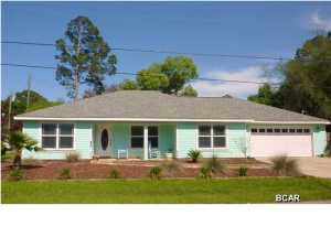Adorable corner lot home in great location! This 3 bedroom 2 bath home is both spacious and open with a split floor plan and oversized kitchen and living room areas. Home offers a side lot perfect for an RV or boat. Location feels like living in the country but just minutes from the worlds most beautiful beaches. No home owners association and lots of open space in front of the property. The residence features tile and wood laminate flooring, granite breakfast bar and huge open kitchen. Rooms are spacious and in addition to the garage, there is much room for interior storage. Built-in entertainment shelves convey. This property will make a great home for the buyer who has time for the short sale process. Investors!! This could make a fabulous rental home as location is just minutes