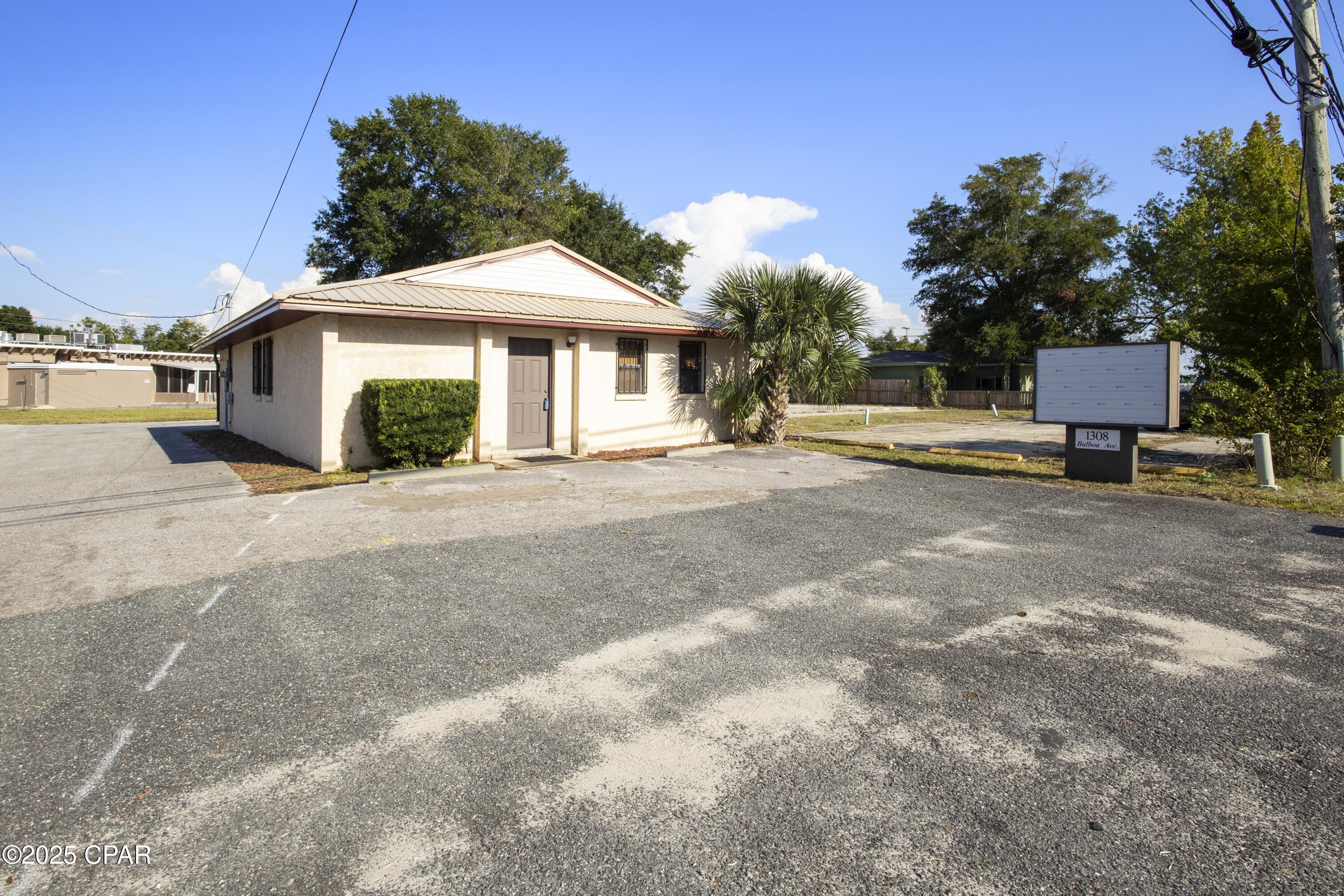 Commercial Building right off 15th Street - Located between St. Andrews and Downtown. This is a versatile property with many possibilities! Features include a spacious open room, a large back room with built-in shelving, one office, two additional work rooms, and a half bath. An exterior attached storage room and a detached 12x24 shed are included, along with a paved parking lot for easy customer and employee access. The building sits on a 50x134 lot and offers a metal roof, block construction with stucco siding, and a prominent sign set up that conveys. Great opportunity for a variety of business uses—call your Realtor today to schedule a showing!