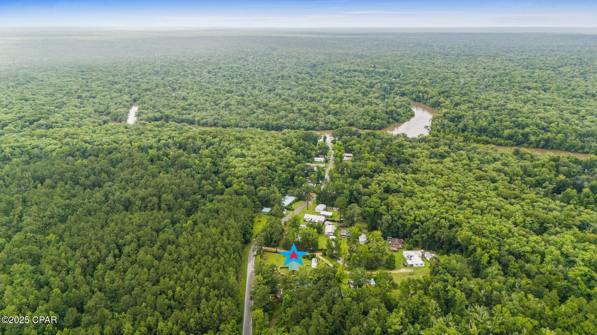 Welcome to Bryant's Landing! This quiet and laid-back community boasts easy access to the Chipola River. Excellent fishing and 1,000's of acres of undisturbed, Northwest Florida Management land.  Perfect for Hunters, Fisherman, and outdoor enthusiasts. This Barndominium is quaint and cozy, custom built in 2022. A nice sized double lot at .60 of an acre. Upon entering, the front porch is the first thing to catch your eye. It is the perfect place to enjoy your morning, and the spot the current owners will miss the most. It's a small cozy home but has a big feel, with 12ft vaulted ceilings in the main space. It is bright and airy, with plenty of natural light. The kitchen features solid wood custom cabinetry and a pantry. Luxury vinyl plank throughout. The Master is spacious and has loft that is perfect for kids or grandkids It also has a nice walk-in closet and several built-ins for storage. You really must see to appreciate the thought and attention to detail when creating this place. Once outside you have a detached garage with laundry hook-up and a sink. A storage building with a half-bath, and another building for storage. The yard is partially fenced for pets. Fruit trees such as orange, tangerine, and grapefruit. Only 1300 feet to the Chipola River and boat launch, but just far enough to be out of the flood zone. Head out fishing or just a peaceful cruise down the river on a pontoon. Excellent overall proximity as well. Just 30 minutes to Mexico Beach, 25 minutes to Port St. Joe, and 35 minutes to Panama City. Community water and sewer. Schedule your visit!