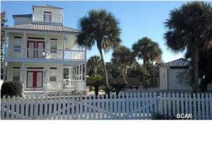 The amount of land on this property is almost 3 times the size of most of the other lots on this very street. This property has room for a pool or a large addition to the back of the house. Imagine a swing on the front porch, palm trees swaying in the gentle breeze, fruit trees in your back yard, the charm of a golf cart friendly neighborhood with a dedicated beach, the wrap around covered porches on the first two floors and open balconies with unbelievable views on the top floor! There are 3 bedrooms, 3 baths and even an EXTRA room that is perfect for a 4th bedroom or for an office! Total it up and you have a beautiful home with more than 3000 square feet counting the porches! Add a detached garage that has a workshop in it, storm coverings, a great community, and the best of