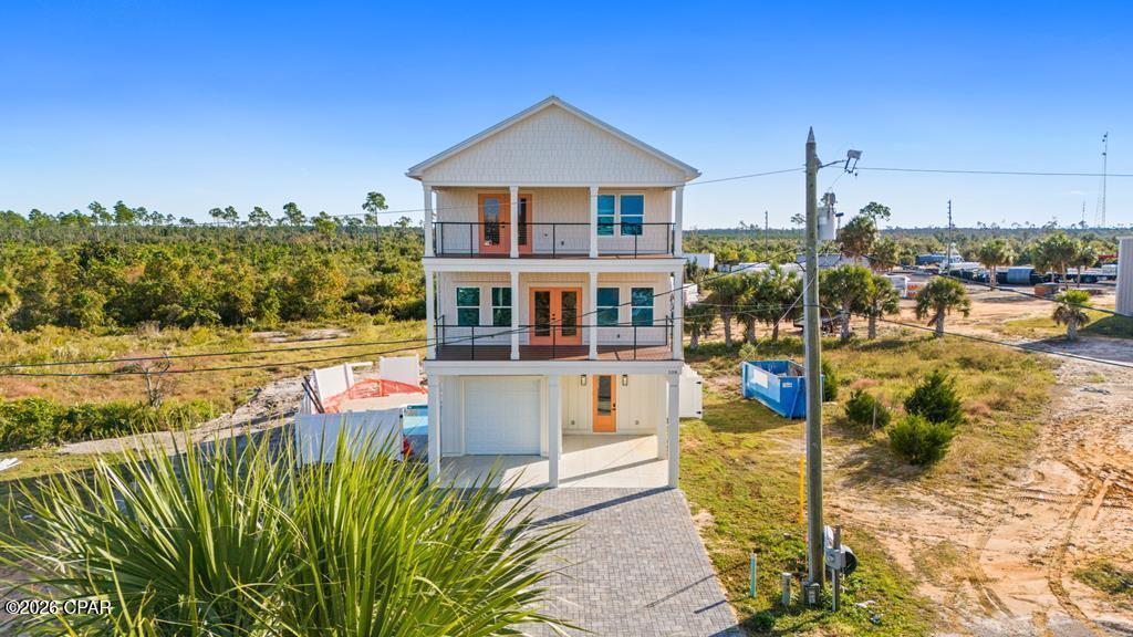 Welcome to 108 N 32nd St, a brand-new 4BR/3BA home perfectly situated in the heart of Mexico Beach, just 1,000 feet from the nearest beach access and steps from local favorites like Mango Marley's, the future grocery store, coffee shops, and Ace Hardware. Built with both comfort and style in mind, this home offers 1,872 square feet of living space and Gulf views from both balconies. The interior features LVP flooring throughout with a kitchen that includes soft-close cabinets, quartz countertops, stainless steel appliances, and a tile backsplash. The open-concept living area is warm and inviting, featuring shiplap walls and wood accents that bring a true beachy feel. Off the living room, enjoy a 14-foot-wide covered balcony with Trex decking, the perfect spot for morning coffee or evening sunset views over the Gulf. Every bathroom features a fully tiled shower, and the primary suite stands out with a private covered balcony, dual vanities with a tile backsplash, and a large walk-in shower. Outside, the home is designed for low-maintenance enjoyment with a heated gunite pool surrounded by pavers, a fenced yard, and an outdoor shower for rinsing off after the beach. Additional features include ample parking, covered golf cart parking, and plenty of outdoor storage. Best of all, this home is being sold fully furnished with high-end furniture, making it completely turnkey, whether you're looking for a full-time residence, a vacation getaway, or an investment property ready to generate income from day one. Quality construction, a prime location, and nothing left to do but enjoy it. Call today!