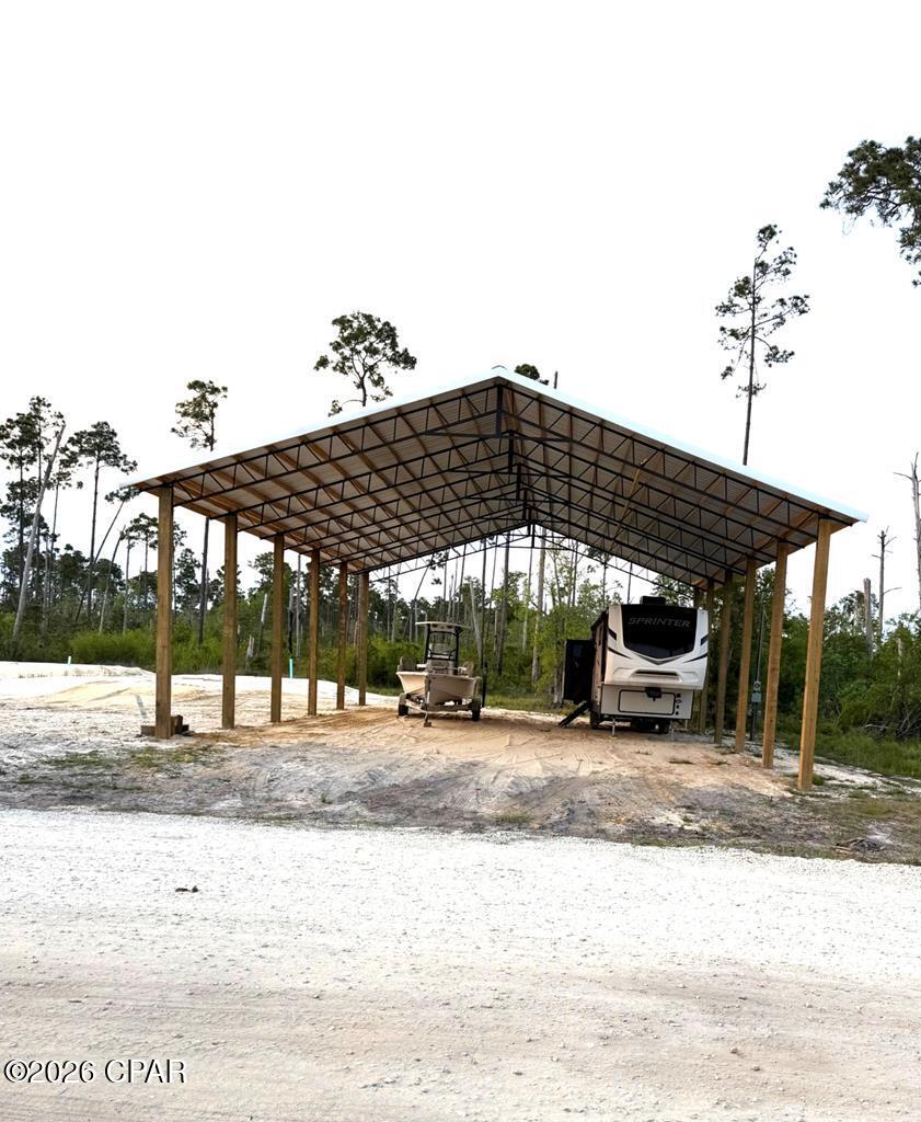 This 1 acre lot is only 4 miles from the beautiful white sands at Mexico Beach. It is also only 2 miles to the intercoastal boat ramp. Property includes a 40' x 60' pole barn with RV hookups ready to make your coastal getaway. Key features include convenient access to CR 386 from a private drive with no thru access. Ample room for extra parking and storage. A 3 bedroom septic system ready for your customization of the barn area. Don't miss an opportunity to own this highly desired property at a very appealing price. All improvements to be completed by July 1st.