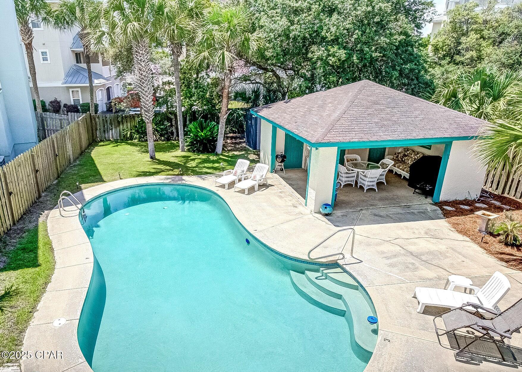 This charming cottage is the ultimate beach retreat--just a block from our beautiful white sands and tucked away to escape the crowds. Whether you're seeking your own personal getaway, an investment opportunity, or a property with short term rental ability, this one has it all. The home comes fully furnished and ready to go, featuring two spacious king bedrooms, each with its own private bathroom. One of the standout features? Your own private pool and cabana--perfect for those days when you want to cool off without getting sandy. Whether it's a quick dip after the beach or a laid-back afternoon by the water, it is an appreciated feature. A personal storage closet and shed offer additional space for beach supplies and more. Whatever tickles your fancy, this location delivers! You're just minutes from the luxury and charm of 30A--without the 30A price tag. Prefer a livelier vibe? Pier Park is only 6 miles, offering shopping, dining, and entertainment in the heart of Panama City Beach. No HOA fees and only three owners in the building. Owners share expenses for common areas, keeping things simple and cost-effective. The building has just been updated to public sewer access (no more septic!) and new electrical boxes. Turnkey ready for living or renting. Just hand over the keys and move right in! Measurements approximate, buyer to verify if important.
