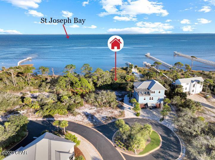 BAYFRONT DREAM SETTING!! Build the coastal home you've always imagined at 124 Pinnacle Dr in the premier gated community of Ovation on North Cape San Blas. This exceptional bayfront lot offers captivating views of St. Joseph Bay, providing the perfect backdrop for stunning sunrises, coastal breezes & unforgettable waterfront living.  Ovation is one of the most sought-after communities on the Cape, known for its beautifully landscaped streets, native plants, swaying palms & architectural standards that preserve the neighborhood's upscale character. Owners enjoy deeded access to both the Gulf & the Bay, creating endless opportunities for beach days, boating, fishing, kayaking, paddle boarding & exploring the natural beauty of Florida's Forgotten Coast. Community amenities are second to none, featuring an infinity-edge bayfront pool, Gulf-side pools, clubhouse, fitness center, tennis courts & scenic boardwalks leading directly to beach access. Miles of paved walking & biking trails invite you to enjoy the outdoors while taking in the area's breathtaking scenery. Spend your mornings watching dolphins play in the bay & your evenings enjoying spectacular sunsets over the water.  Nearby, St. Joseph Peninsula State Park offers pristine beaches, abundant wildlife & world-class fishing. You'll also appreciate the convenience of locally owned restaurants, fresh seafood markets, boutique shopping & live entertainment just a short drive away. Whether your ideal day includes relaxing on the beach, casting a line from the shore or exploring the coastline by kayak, North Cape San Blas offers something for everyone.  Whether you're planning a full-time residence, vacation retreat or investment property, Ovation continues to be a favorite destination with proven rental appeal & lasting value. Don't miss this opportunity to secure a premier bayfront homesite in one of Cape San Blas' most desirable communities. Call for your private tour & LIVE THE BEACH LIFE!
