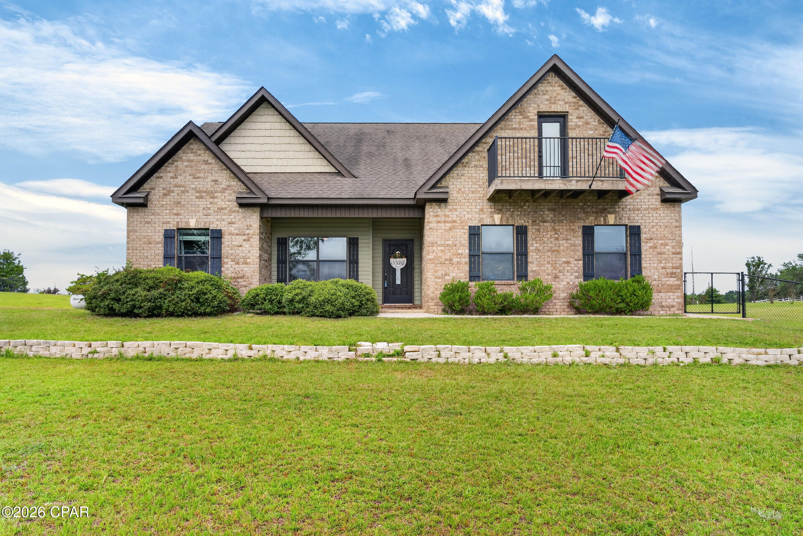 Beautifully designed and full of thoughtful features, this 4-bedroom, 3-bath custom brick home in Russ Lake Estates offers comfort, space, and a great location. The main level features an inviting open floor plan with a spacious living area, electric fireplace, and trey ceiling. The kitchen offers a breakfast bar, pantry, and adjoining dining area with French doors that open to a covered patio, making it easy to enjoy both indoor and outdoor living. The primary suite is located on the main floor and features a trey ceiling, walk-in closet, garden tub, separate shower, and private bath. Two additional bedrooms and a guest bathroom are also located downstairs.

Upstairs, you will find a versatile bonus room with a balcony that could serve as a fourth bedroom, office, entertainment space, or even an additional suite. This level also includes a full bathroom and walk-in attic access for convenient storage. Additional features include an attached two-car garage, a home generator for added peace of mind, a nice corner lot, and access to Russ Lake for fishing. Centrally located between Chipley, Graceville, and Bonifay, this home offers a wonderful blend of privacy, convenience, and functionality.