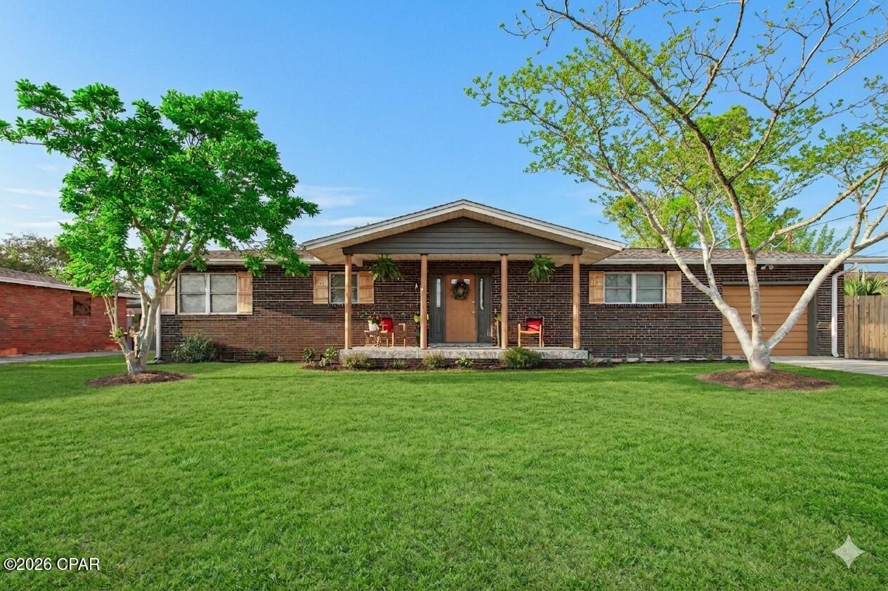 Check out the best value in East Panama City, which comes with a one-year warranty on both the home and the pool. Located just six miles from the gates of Tyndall Air Force Base, this move-in-ready spot is perfect for anyone looking for a relaxed, tropical vibe with all the right modern upgrades.
The interior offers a bright, open floor plan that has been freshly painted and is completely carpet-free, featuring durable hardwood and tile flooring throughout. The kitchen has been updated with sleek granite countertops and offers plenty of room to prep meals while staying part of the conversation in the living area. Every inch of the three-bedroom, two-bath layout has been upgraded, so all you really need to do is unpack. If you want to make the move even easier, there is even an option to purchase the home fully furnished for an additional price.
The backyard is a total retreat, featuring an in-ground setup with its own private sand island that brings the beach right to your door. The home features a separate well for watering grass, plants, and maintaining the pool. This is a huge savings for the homeowner as this water is not billed for sewer. For those who love the outdoors but  need some shade, the large screen room is the perfect spot for dining alfresco or just chilling out. The entire yard is already fenced in, so you can let the pets and kids run free with plenty of privacy and protection. Practicality is a huge plus as well, with a deep garage and extra driveway space for guests. There is also a cement pad for your boat or RV behind the fence!