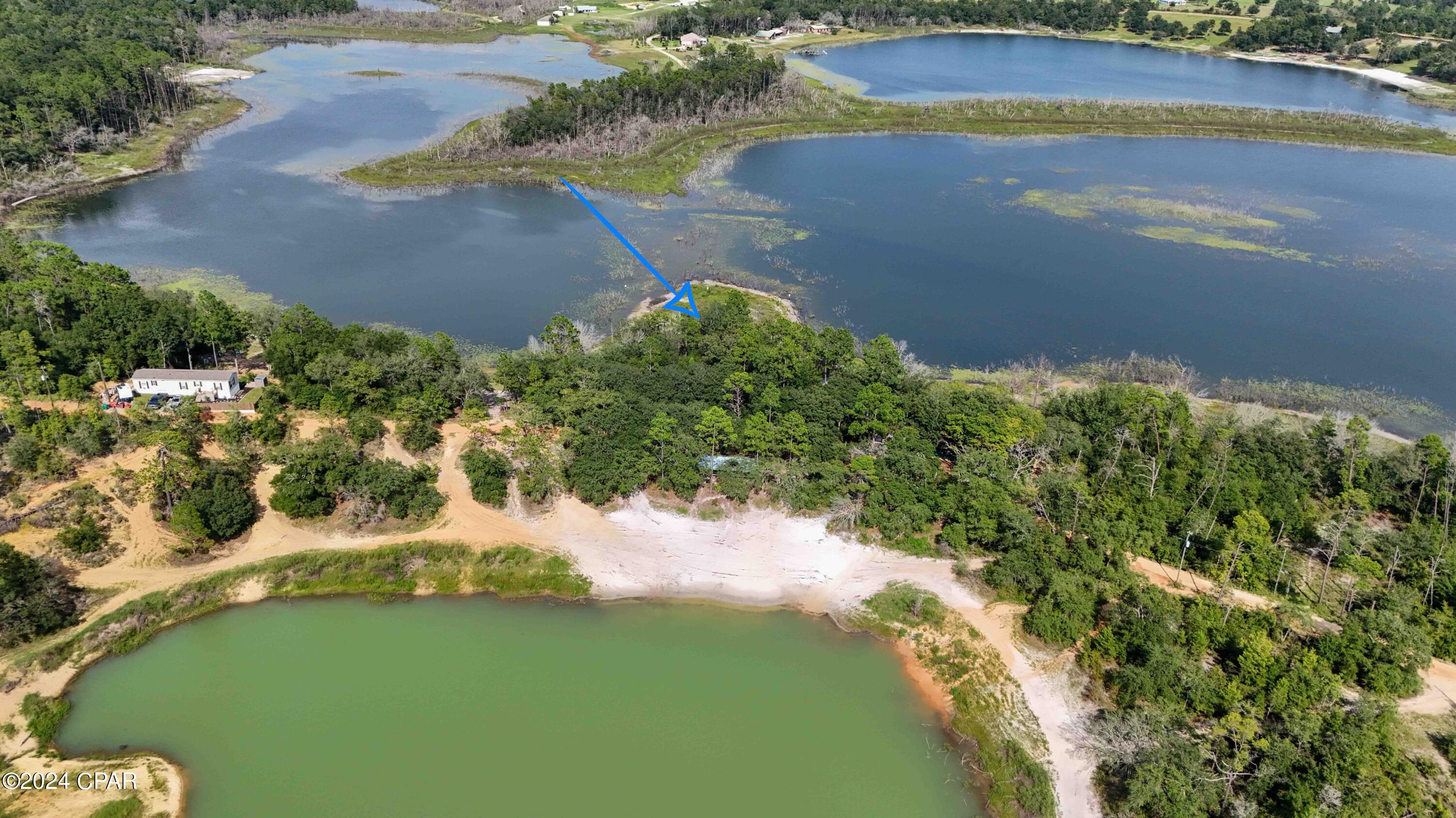 Get your piece of this natural private oasis at Spring Pond. This property boasts 149.5 feet of waterfront, primed for fishing, kayaking, or just enjoying the serene nature around you. Beautiful mature hard woods on the property would accentuate a nice big yard if someone chose to build a home. There is a community sandy swimming area right across the street along with a large pavilion with picnic tables for gatherings. Go check this lovely piece of vacant property out today!