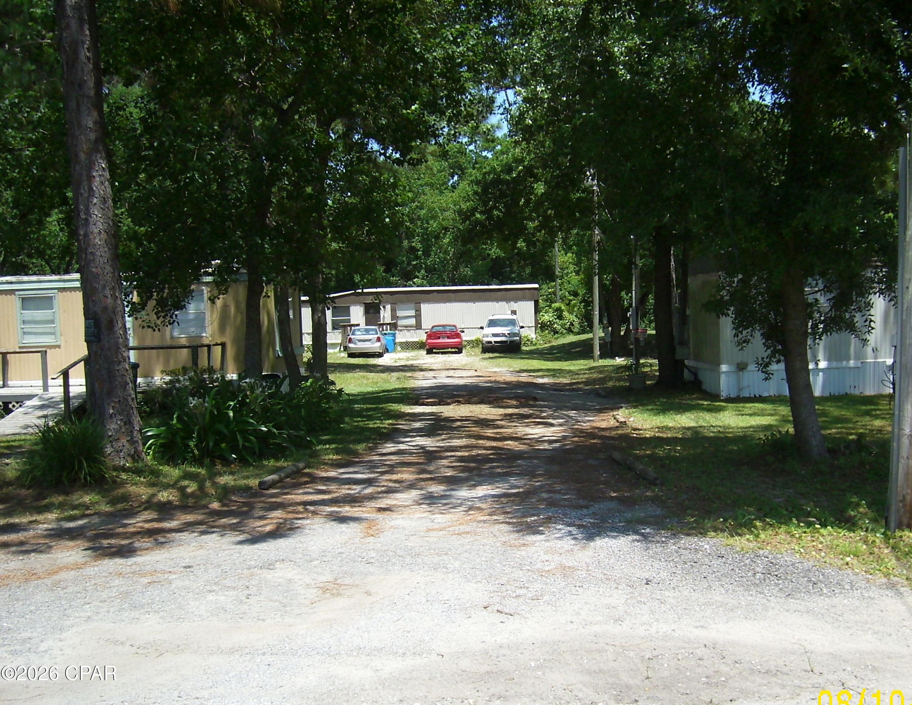 This investment collection is part of 3 lots that can be purchased individually or all together.  This one is Parcel ID's 27779-020-010.  The existing mobile home is occupied. Potential remodeling could add value to the mobile home and property. 

The property is zoned R-2(BC) which permits two townhomes to be built or a duplex. Buyer can purchase one property or all three at one time. Each property has it's own septic and sewer is available nearby. A power pole is also on each property. The white mobile home and the storage unit on 2412 Dorothy A&B does not convey. Possible financing available with a builder to build your investment/income property.