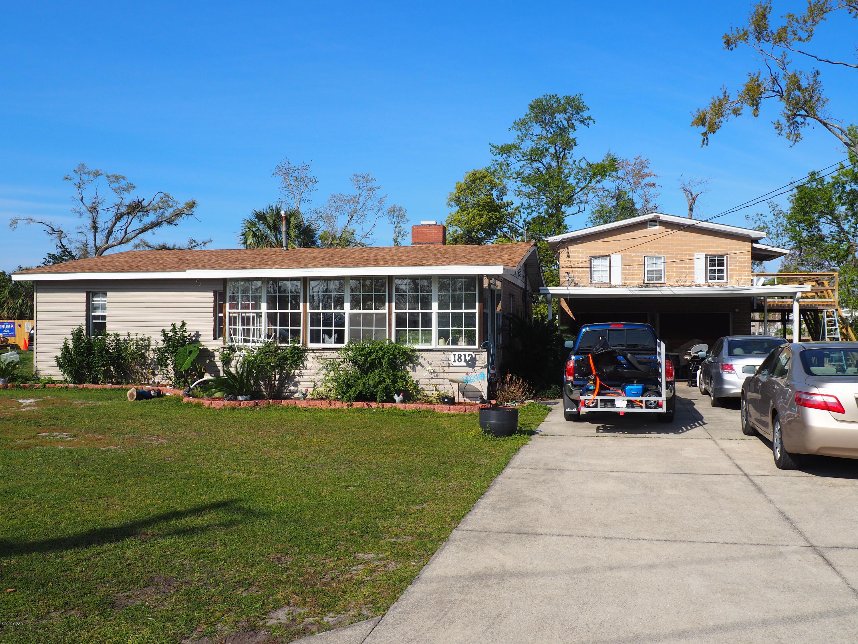 Great investment opportunity on a 2 bedroom 1 bathroom house with a 1 bedroom 1 bathroom apartment above the garage. New roof replace December 2018. Live in one and rent the other out. Located close to schools, parks, water activities, restaurants, and shopping. Custom bathroom has large Jacuzzi tub and separate shower. Tongue and groove ceilings and crown molding add character to cozy home.   Enjoy relaxing evenings or morning coffee in the front enclosed sunroom. Fenced in yard is great for kids and pets to run around. 24X20 workshop and storage building in the back yard with a 24x12 carport for those weekend mechanics. Upstairs apartment with its huge deck, full kitchen, bathroom and laundry room.