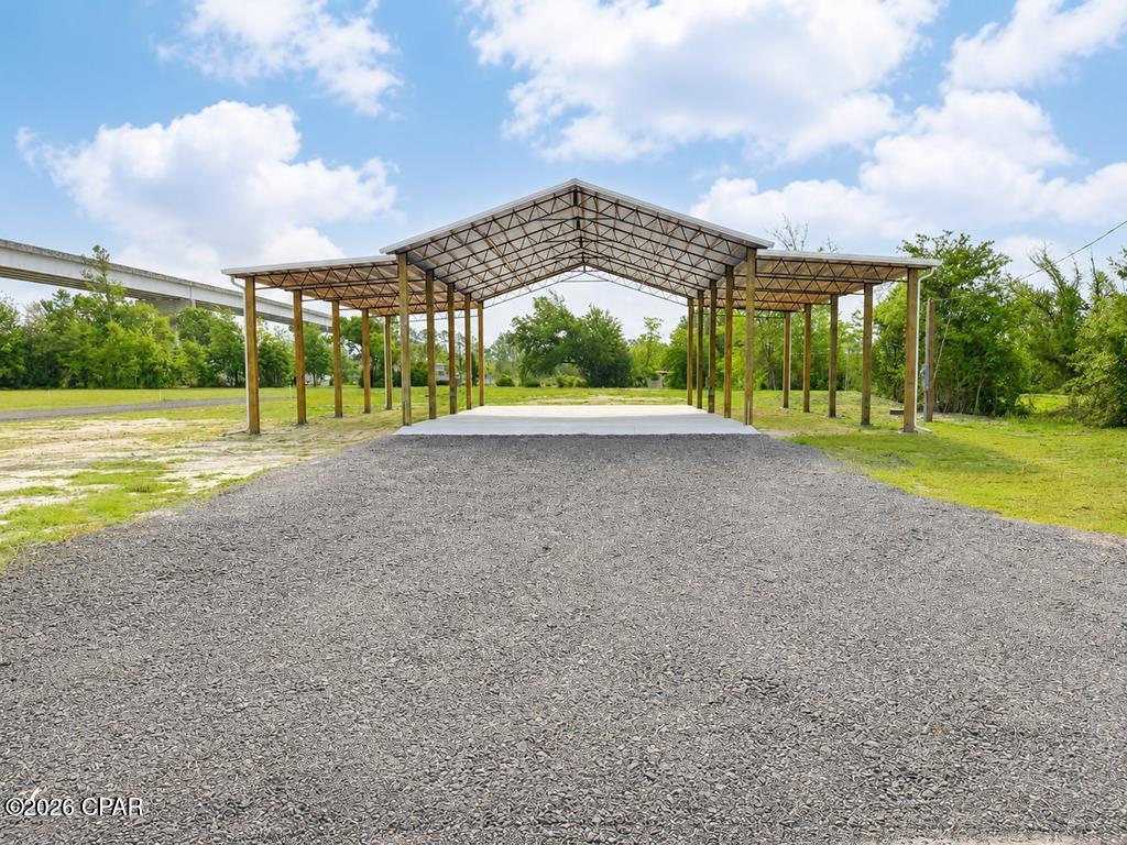 RARE IMPROVED 0.50-ACRE LOT WITH WATER VIEWS & EXCEPTIONAL INFRASTRUCTURE ? OVERSTREET, FL. Don't miss this unique opportunity to own a fully improved coastal property just steps from the Hwy 386 bridge and public boat ramp, offering quick access to the Intracoastal Waterway, Gulf of Mexico, Mexico Beach, and Port St. Joe. This is far from a typical vacant lot & the groundwork is already complete, making it ready for immediate use or future development. The property features a 32' x 48' x 16' tall pole barn with (2) 14' x 48' x 14' lean-tos, providing substantial covered space for storage, equipment, or future build-out. The layout offers flexibility for a potential barndominium-style conversion or living quarters (buyer to verify all zoning and permitting requirements). The structure is supported by a reinforced concrete slab with a 12-inch footer, delivering strength and long-term durability. Extensive utilities and improvements already in place include: 200-amp meter panel (2) 100-amp panels (2) 50-amp RV hookups (2) Sewer and water connections Septic system sized for a 3-bedroom / 2-bath future residence The property also features a circular driveway with a large culvert, allowing easy access for RVs, boats, trailers, and equipment. Whether you're looking for a coastal basecamp, investment opportunity, storage facility, or future homesite, this property offers exceptional versatility with major infrastructure already completed. A rare find this close to the water with improvements already in place & ready for immediate use or your next vision.