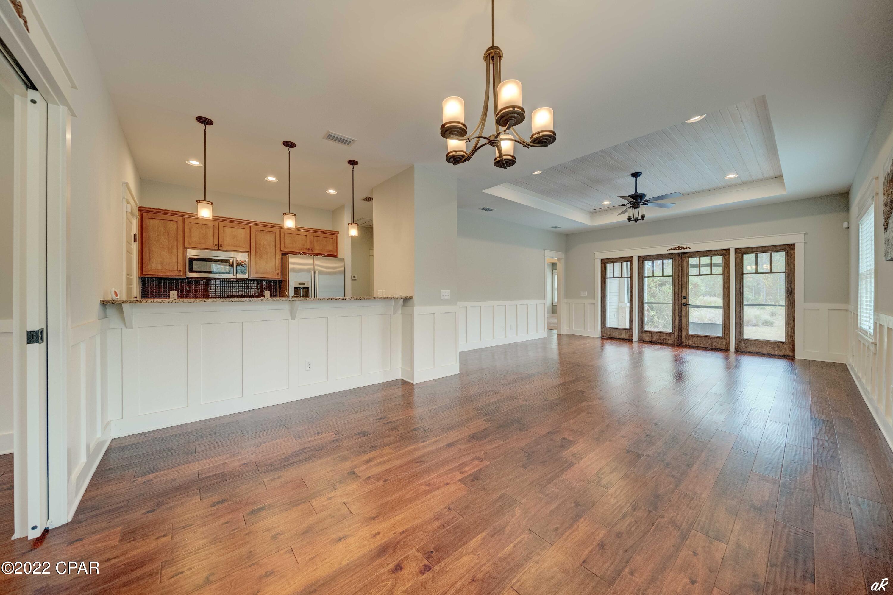 UNDER CONTRACT WITH CONTINGENCIES; SELLER ACCEPTING BACKUP OFFERS.

Brand new exterior paint and brand new HVAC. Looking for a private oasis to call home with luxurious amenities at your fingertips including access to serene Lake Powell, a lakeside pool and fire pit, nature trails and Greg Norman designed Shark's Tooth Golf Course? This terrific 1,505 sq ft 3-bedroom, 2-bath home is located on the third fairway of Norman's Shark Tooth Golf Course in Wild Heron, a prestigious gated golf community. The home has a beautiful paver stone entry and driveway with a 2-car garage. Upon entry you are greeted with custom hardwood floors throughout the main living areas & tile floors in the kitchen and bathrooms. The home is beautifully designed with tray ceilings in the living room, great room and master bedroom. The luxurious en-suite master bath features a double vanity with granite countertop & soaking tub.

The elegant double doors of the great room lead out to the tranquility of the enclosed patio, the perfect spot for entertaining outdoors or just relaxing with a good book while enjoying the serenity of the lush, natural surroundings. These doors can also be closed off for added privacy. Beautiful craftsman details like the wainscoting, trimmed windows & doors and wood lined trayed ceilings truly make this home exquisitely unique. The open kitchen features a large granite breakfast bar great for casual dining and is accented with pedestal lights. There are top of the line, stainless steel Bosch appliances, ample hardwood cabinets, recessed lighting and custom tile backsplash. There is a dining area for a more formal setting. The master suite is quite spacious with an en-suite bathroom and there are two guest bedrooms with an additional bath. The home has been well maintained and will be a fantastic full time residence or second home in one of the most unique and beautiful communities in Panama City Beach. Full size washer & dryer is negotiable.

Residents of Wild Heron have access to the community boathouse which offers complimentary kayaks to explore pristine waters of the preserve. Keep fit with tennis courts and a fully equipped fitness center on-site. Afterwards, enjoy a relaxing dip in the lakeside community pool and/or hot tub. You have access to two pools for your enjoyment. Golfers of all skill levels will enjoy the Greg Norman designed Shark's Tooth Golf Club course which was awarded Silver Signature Sanctuary Status by Audubon International for its commitment to environmental excellence. After a game of golf, head over to the clubhouse bar and grill to unwind with some drinks and good food. As if all of the Wild Heron amenities were not enough, Panama City Beach attractions are less than 15 minutes away!