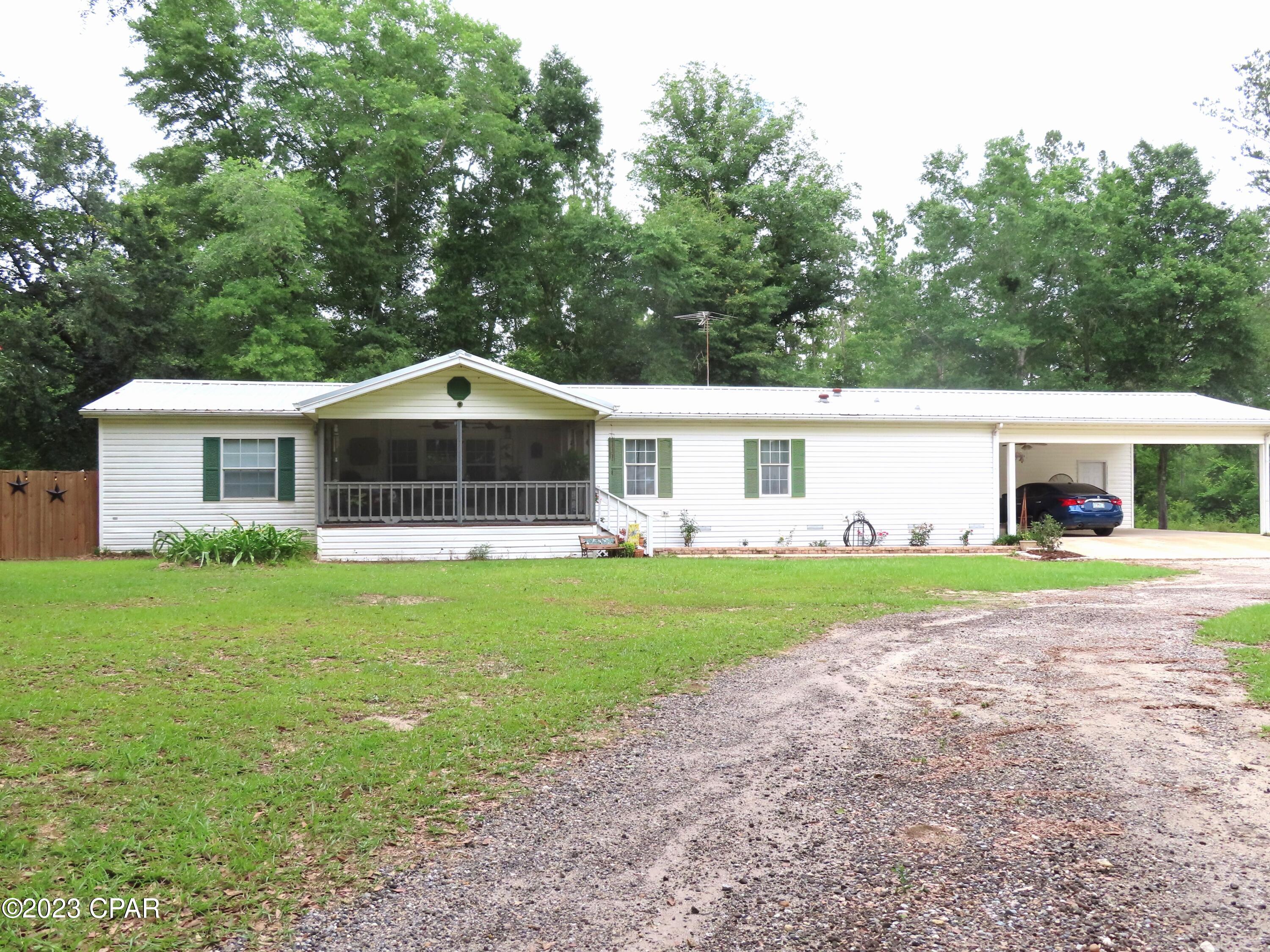A little country living on  5 + acres not too far from the city.  This 3BR/2BA Palm Harbor Double Wide mobile home includes a split floor plan that features many updates  including a new HVAC installed in 2022, water proof laminated plank flooring, 40 gallon hot water heater, S/S refrigerator, and updated plumbing. This home has so many extras and you will enjoy the seasons from the spacious screened-in front porch or sunroom. The carport area includes storage, 2nd laundry area, and 1/2 bath. There is also an additional 10x16 storage shed.  Call for your appointment today!