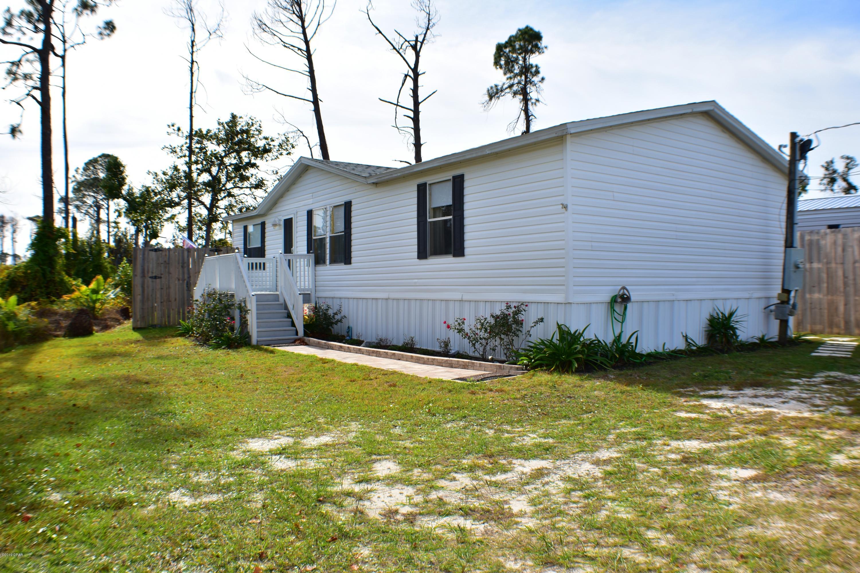 CURRENTLY UNDER CONTRACT, SELLER ACCEPTING BACKUP OFFERS. Remodeled and move-in ready 4BR/2BA manufactured home in the Magnolia Estates area of Panama City Beach. The roof is less than a year old & the home has new doors & privacy fencing which encloses a large back deck with built-in hot tub, an above-ground pool & a fire pit! This is a great location for a second/vacation home or as a full-time residence! The home features a split-bedroom floor plan & all of the BRs have walk-in closets. The kitchen has new flooring and sellers had new stainless steel appliances installed. There are 2 entrances to the home so the 4th BR could be a M-I-L suite. The home is near Waterhaven which allows Magnolia Beach residents to use their boat ramp & there is plenty of room to park a boat &  several vehi You're also convenient to shopping, schools, golf courses and the beach! All info is approx and must be verified by Buyers if important.