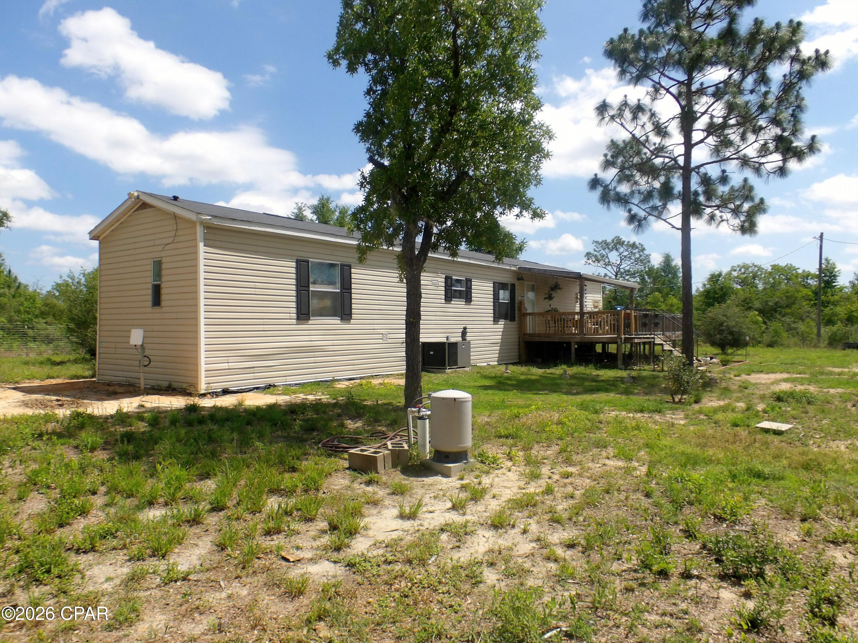 Facing a paved and dirt road, on a corner lot, cute newer three bedroom two bathroom home on a 5.71 acre lot in Quail Hollow offered as is.  The lot is fenced and has two sheds.