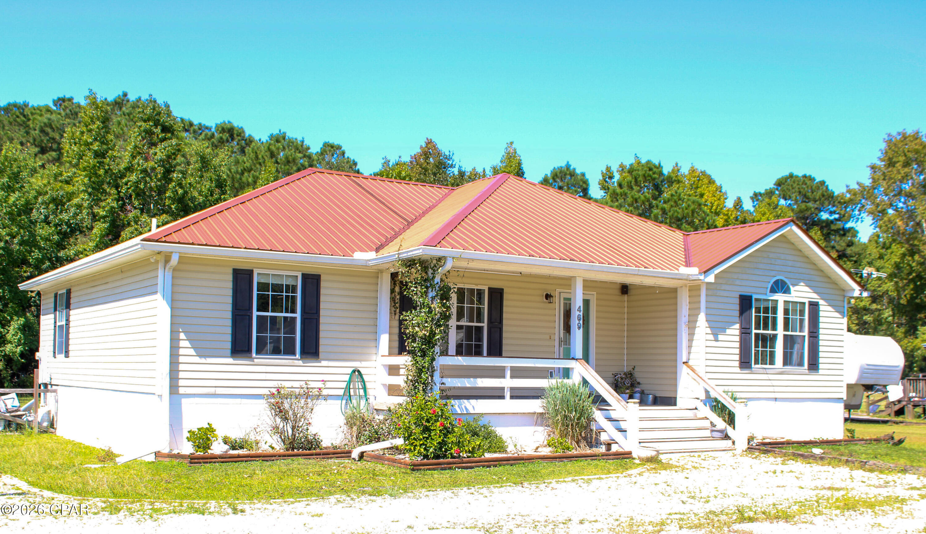 Welcome to Howard Creek - a quiet, outdoorsy community where nature and adventure meet. This 3BR/2BA home offers 1,608 sq ft on a 1/2 acre lot, with plenty of space for a boat or RV and a porch made for slow evenings and coastal breezes. Inside, enjoy a spacious living area with a brick-face fireplace and a large master suite. Out back, a brick paver patio creates the perfect space for cookouts, entertaining, or unwinding after a day on the water. Just minutes to the public boat ramp, you can spend mornings fishing the creeks or Apalachicola River, then be in historic, charming Port St. Joe in about 20 minutes to enjoy its coastal shops, cafes, and dining. In roughly 30 minutes, your toes can be in the sugar-white sands of Mexico Beach. Updates include LVP flooring (2021), water heater (2021) and patio. Whether you're looking for a peaceful retreat or a convenient base for coastal adventures, this home offers the best of both.