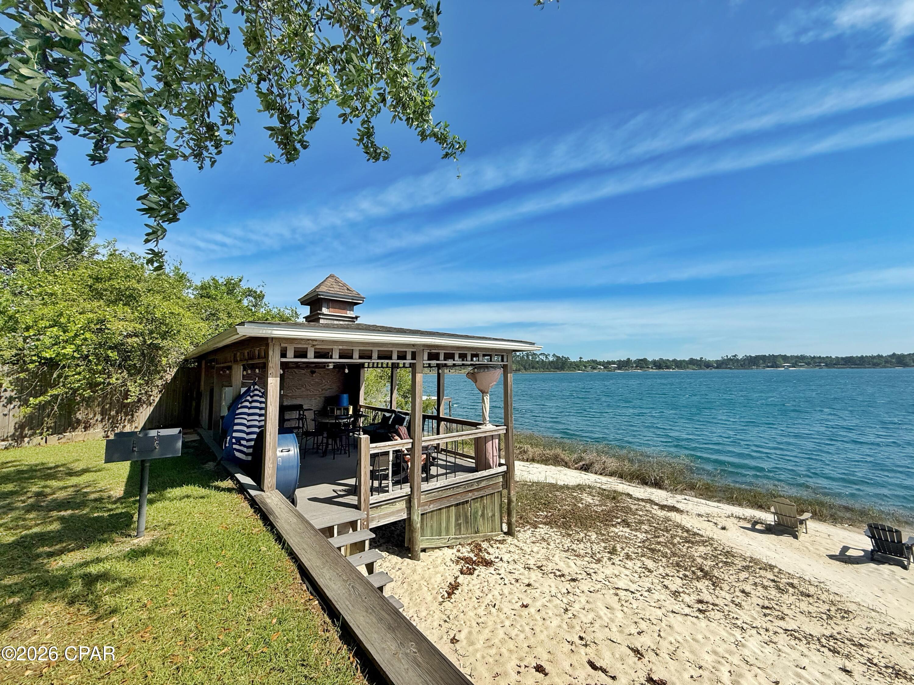 Experience the perfect blend of privacy, comfort, and lakeside living with this exceptional waterfront lot on Silver Lake. Fully fenced and gated with an automatic entry, this property offers a rare opportunity to enjoy a serene, secure retreat surrounded by natural beauty.

The lot is fully equipped with a well, septic system, and 220-amp electric service, making it move-in ready for weekend getaways or extended stays. A covered RV setup includes a 2018 RV that conveys with the property, along with a separate carport for additional parking or storage.

Two versatile sheds--both with electricity and window A/C units--expand your living and utility space. One shed is fully outfitted with a washer and dryer hookup, complete with units, while the second includes a convenient bathroom with sink and toilet, perfectly positioned for easy access from the lake.

At the water's edge, you'll find everything you need to enjoy this pristine, spring-fed lake. Relax on the covered Trex deck with ceiling fan, ideal for shaded afternoons and lakeside grilling. A stunning white sand beach leads to your private dock, complete with a super slide and rope swing for endless fun on the water.

Silver Lake's electric-motor-only policy helps preserve its peaceful atmosphere and crystal-clear waters, making this an ideal destination for those seeking tranquility without sacrificing recreation.

Whether you're looking for a private escape, a family retreat, or a unique investment, this one-of-a-kind waterfront property delivers it all.