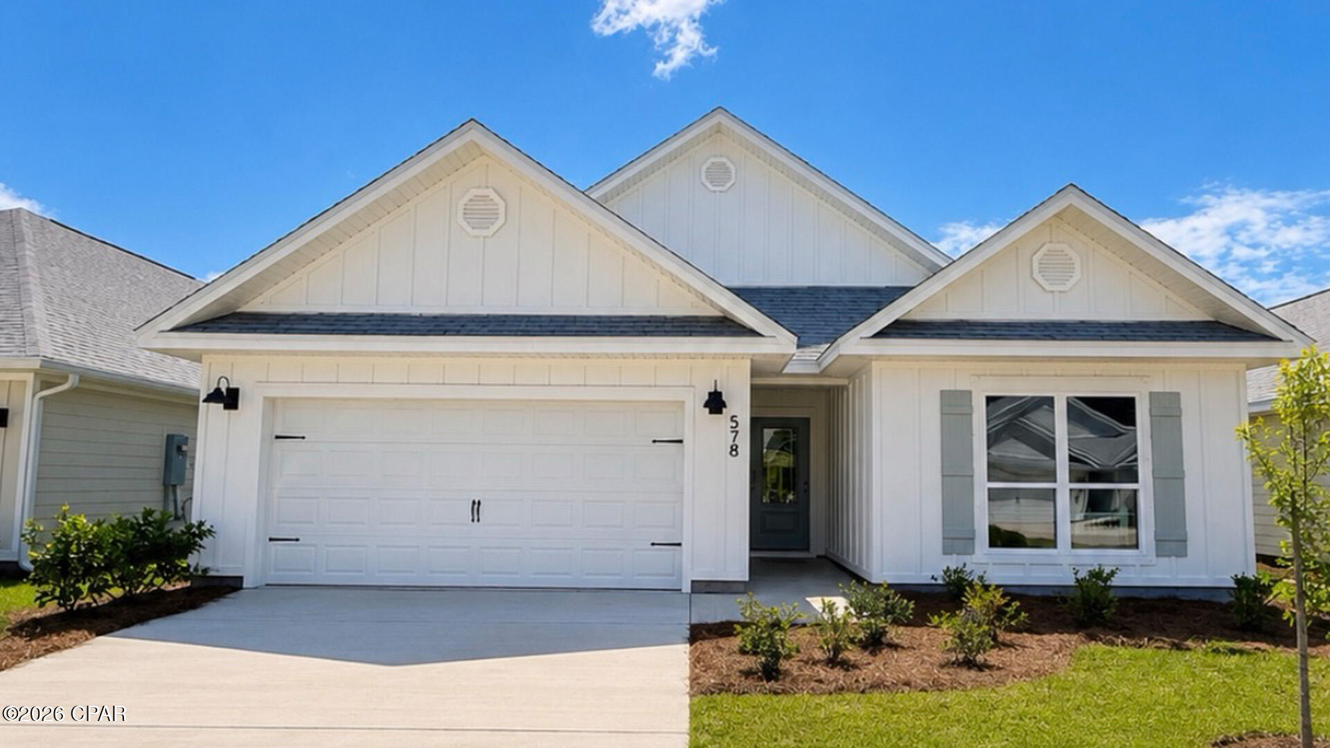 Welcome to 585 Hancock Way at Bayside at Ward Creek in Panama City Beach Florida. This home is ready for move in and features the Delray floorplan. As you walk into the home you will find two bedrooms off the entry hall with a full bath in between. The laundry room located across the hall is spacious and offers space for storage if needed. There is a fourth bedroom that could serve as an office space/ flex room/ bedroom next to the laundry room. The heart of this home is the spacious living area that is open to the kitchen. 

This floor plan flows seamlessly with beautiful EVP flooring throughout the main living areas and carpet in each bedroom. The kitchen is equipped with brand name stainless appliances including a smooth top stove, microwave, and dishwasher as well as a center island with lower cabinetry. The beautiful white cabinetry compliments the elegant quartz countertops and offers a bright feel to this spacious home. 

The primary bedroom is located at the back of the home offering a private retreat and it features an ensuite bathroom with EVP flooring, quartz countertops and beautiful white cabinetry. The bathroom is designed with two spacious closets, a large shower with glass enclosure and a dual sink vanity