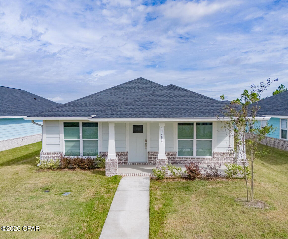 ***OPEN HOUSE: SATURDAY, JUNE 6TH 1:00-3:00PM*** Welcome home to 11403 Godart Street, a beautifully designed 3-bedroom, 2-bathroom open-concept home located in the peaceful and picturesque Sunrise at East Bay community. From the moment you arrive, you'll fall in love with the serene atmosphere and unobstructed water views right outside your front door--perfect for sipping your morning coffee while watching dolphins play in the bay. Inside, enjoy modern finishes, including sleek quartz countertops, a spacious layout, and a large walk-in pantry--perfect for storing all your kitchen essentials. With abundant storage throughout the home, everything has its place. Built in December 2024, this nearly-new home also comes equipped with fabri-shield hurricane shutters for added peace of mind during storm season. This community is known for its rear-load garages, creating a clean and charming streetscape with brick-paved roadways that add to the neighborhood's timeless appeal. Just minutes from Tyndall Air Force Base, this home offers peaceful living with the convenience of nearby amenities. Whether you're relocating, retiring, or simply ready to live a little closer to the water, 11403 Godart Street offers the perfect blend of coastal style, quiet comfort, and smart design.