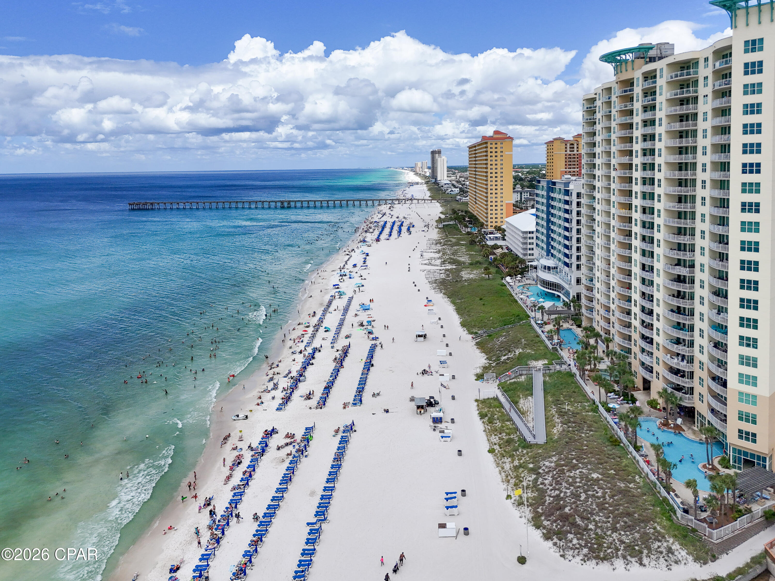 Rare First-Floor Opportunity at AQUA - The Ultimate Vacation Rental or Beach Retreat!

Opportunities like this don't come along often! Unit #111 is one of only two first-floor condos at AQUA, giving guests the convenience of walking directly to the pools, beach, and amenities without waiting on elevators or carrying luggage and beach gear through crowded hallways--a feature renters love and one that helps set this unit apart.

This spacious 1,368-square-foot condo features 12-foot ceilings, an open, light-filled floor plan that comfortably sleeps 6-8 guests, and a private balcony with beautiful Gulf views. The oversized wrap-around patio, accessible from both the living room and primary suite, provides the perfect spot to relax after a day in the sun.

AQUA's resort-style amenities include multiple pools, hot tubs, and a fitness center just steps from your front door. Best of all, you're just a short walk to Pier Park, putting Panama City Beach's premier shopping, dining, entertainment, and attractions right at your fingertips. This unbeatable location keeps visitors coming back year after year.

Whether you're looking to maximize vacation rental income or enjoy your own beachfront escape, this rare first-floor unit offers the convenience, location, and lifestyle that make it a standout investment.